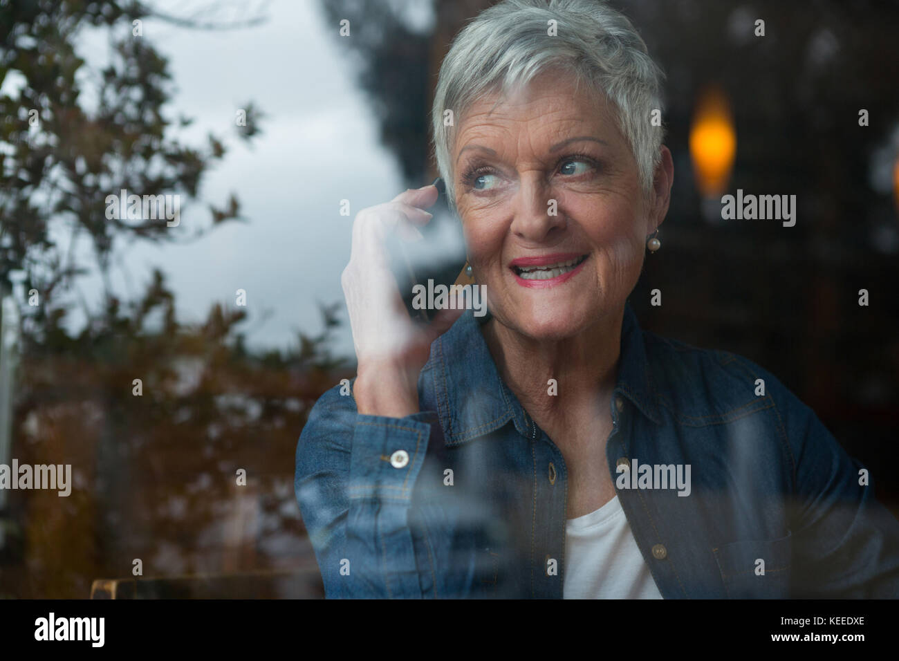 Senior woman talking on mobile phone in cafÃƒÂ© Stock Photo - Alamy