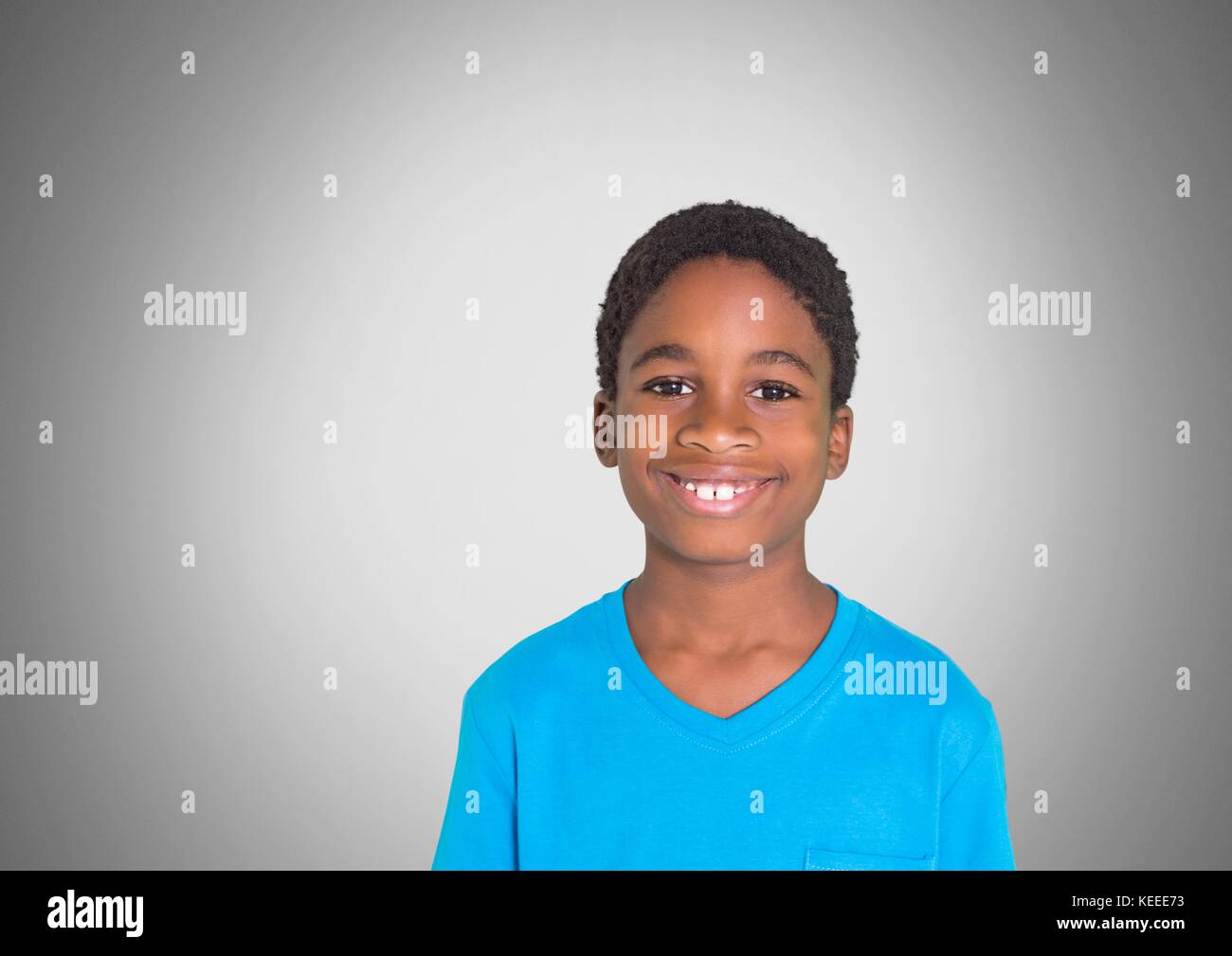 Digital composite of Boy against grey background smiling Stock Photo