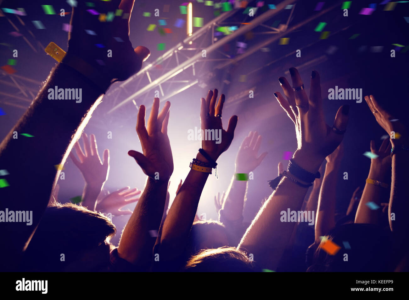 Flying colours against group of people dancing at a concert Stock Photo ...