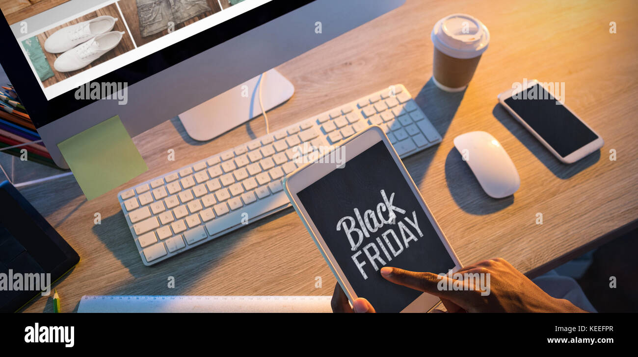 Cropped hands of buisnessman using digital tablet at workplace Stock Photo