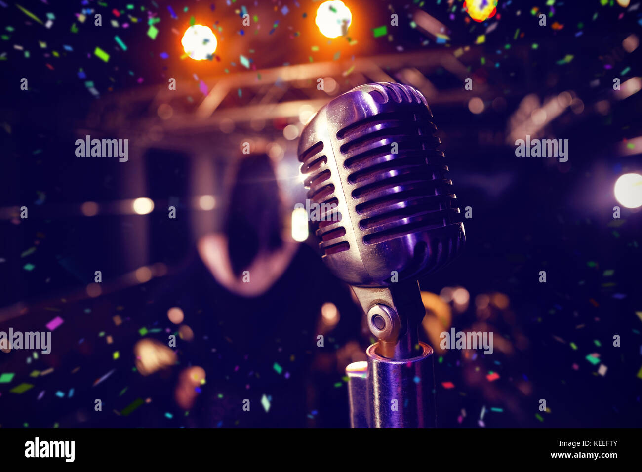Flying colours against retro microphone at concert Stock Photo - Alamy