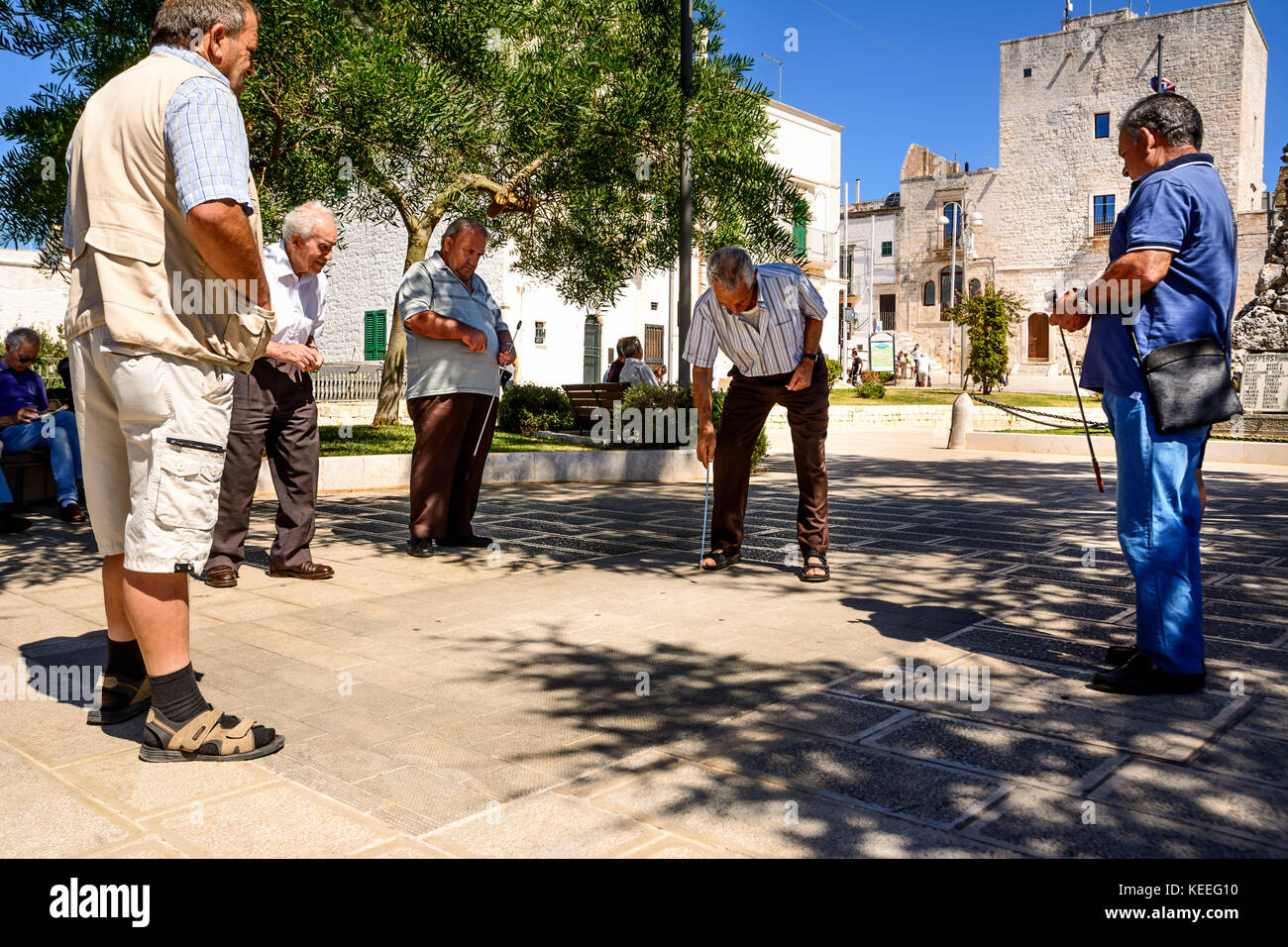 Cisternino, Italy - August 15, 2017: Retired people play in the square Stock Photo