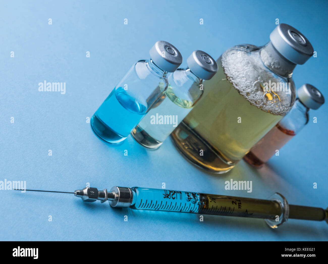 Several vials and syringe in laboratory, conceptual image Stock Photo ...