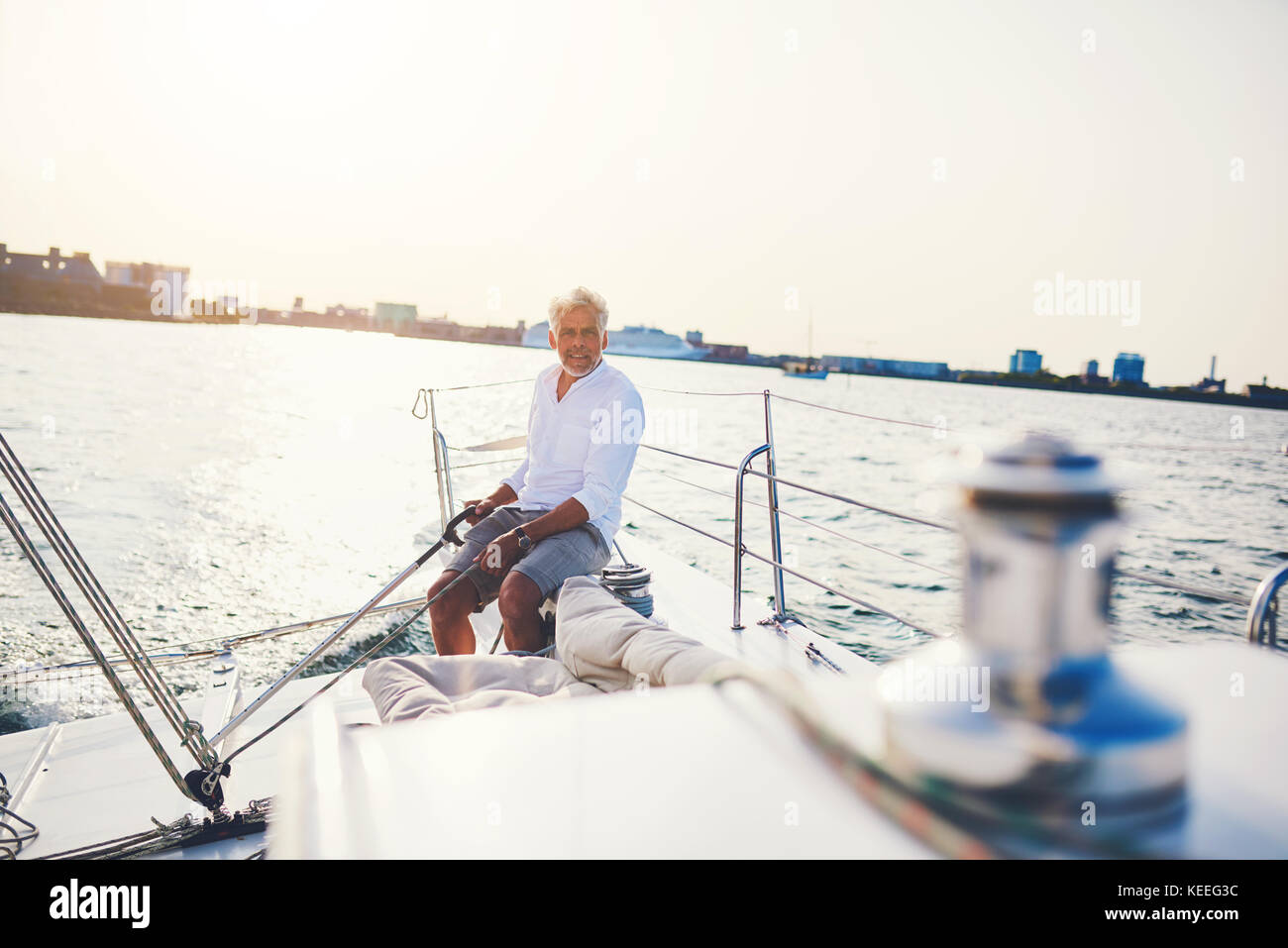 Male steering a boat hi-res stock photography and images - Alamy