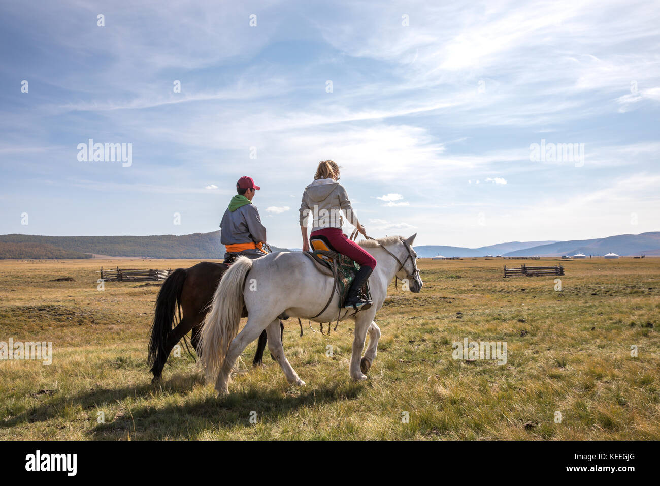 couple riding horses in a landscape of northern Mongolia Stock Photo ...