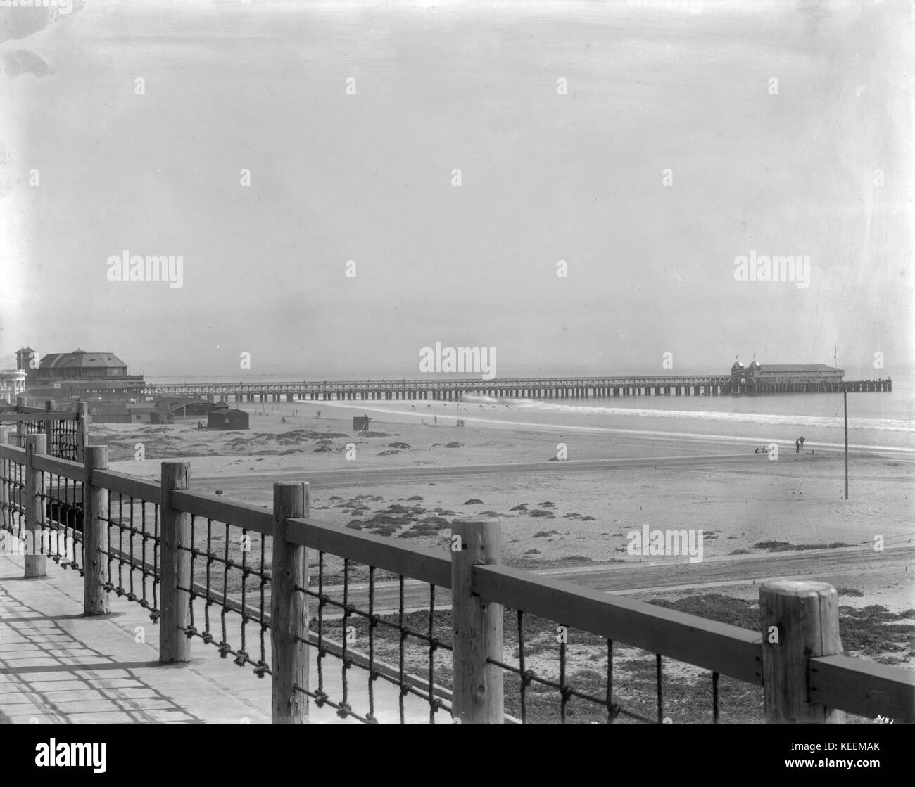 A historical photograph showing a view of the Long Beach pier and pavilion, taken from the promenade at the north end near the Ebel Club House, circa 1905-1910. Stock Photo