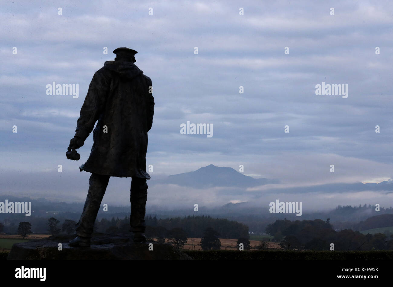 The statue of David Stirling, founder of the SAS, looks over mist around Ben Ledi mountain in the Perthshire hills near Doune, Central Scotland, as the UK is braced for a night of heavy rain and winds before Storm Brian batters the country this weekend. Stock Photo