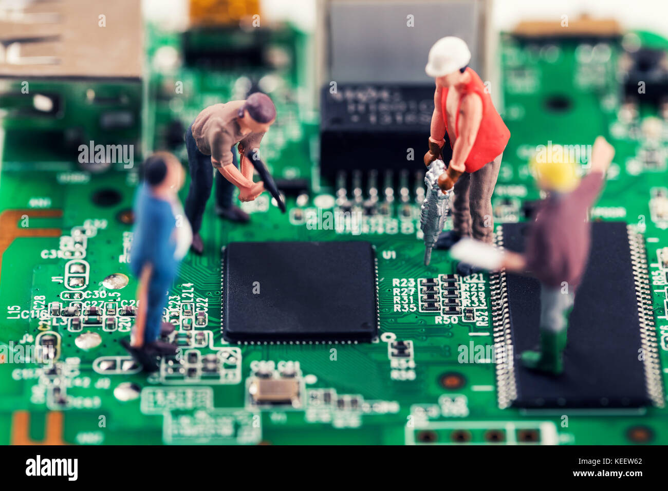 electronics repair and tech support concept - workers repairing circuit board Stock Photo