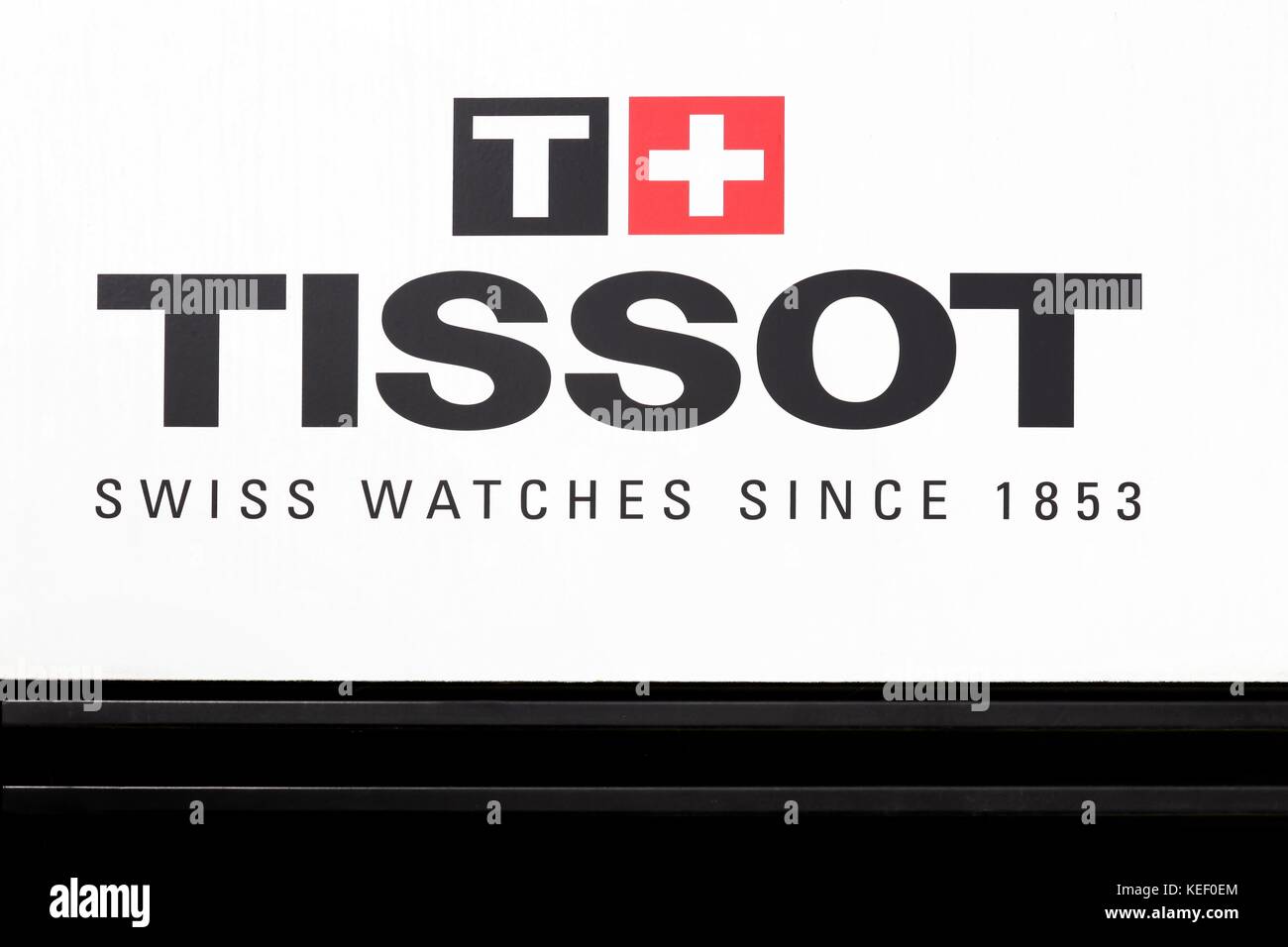 Geneva, Switzerland - October 1, 2017: Tissot logo on a wall. Tissot is a Swiss watchmaker and the company was founded in Le Locle, Switzerland Stock Photo