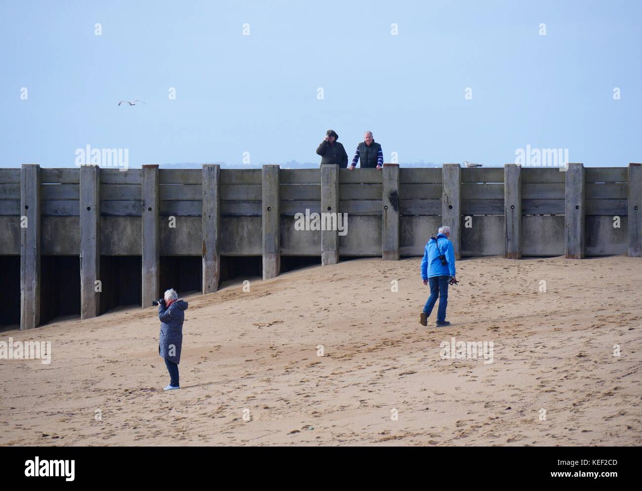 West Bay, Dorset, UK. 20th Oct 2017. UK Weather. People enjoying the relative calm before the storm predicted to hit the UK later today on a sunny but blustery day at the beach. Credit: Dan Tucker/Alamy Live News Stock Photo