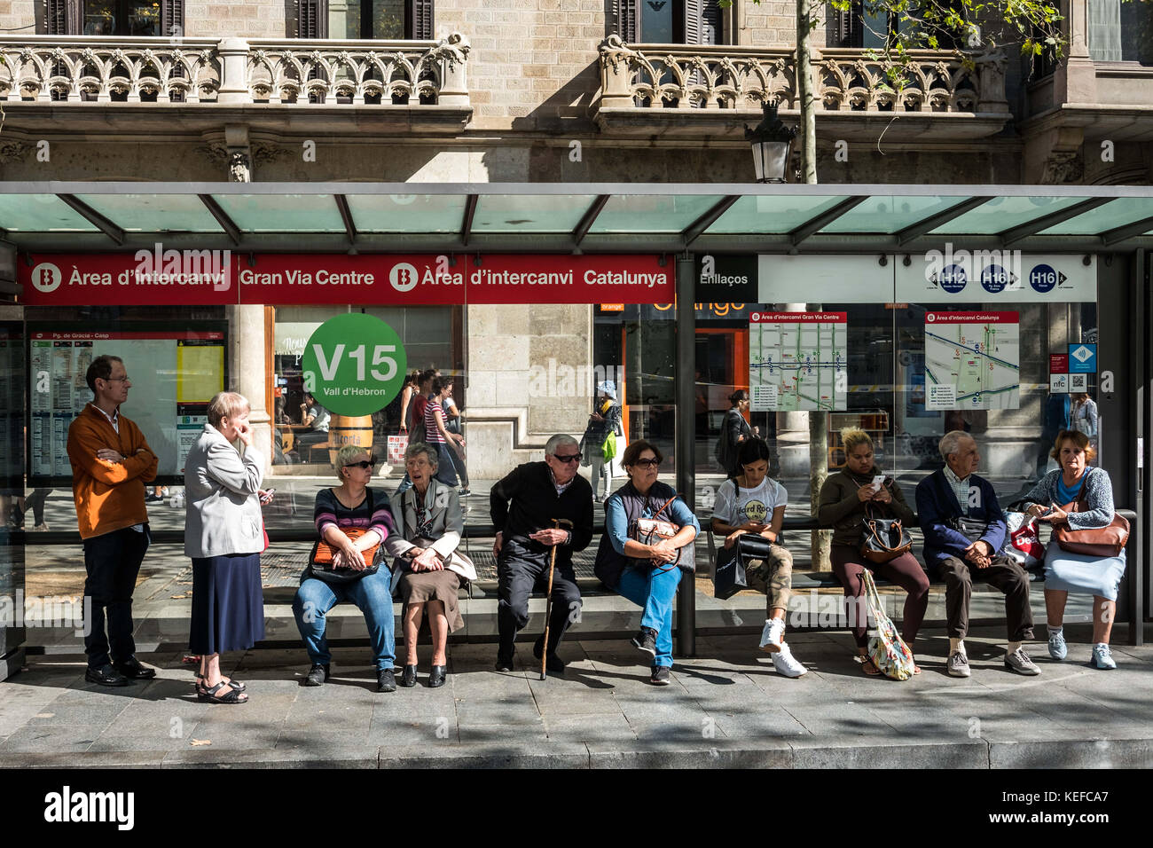 October 21, 2017 - Barcelona, Catalonia, Spain - Several residents are seen while waiting the local buses with some delay on the Paseo de Gracia street..While the Spanish President Mariano Rajoy told at a press conference the new powers to suspend the autonomy of the Catalan authority, Barcelona prepares in the great shopping Avenue of Passeig de Gracia a new concentration of the Catalan independence movement to demand the freedom of the two political prisoners Jordi Cuixart and Jordi AlvÃ rez. Throughout the morning national and international television and media have been deploying its equip Stock Photo