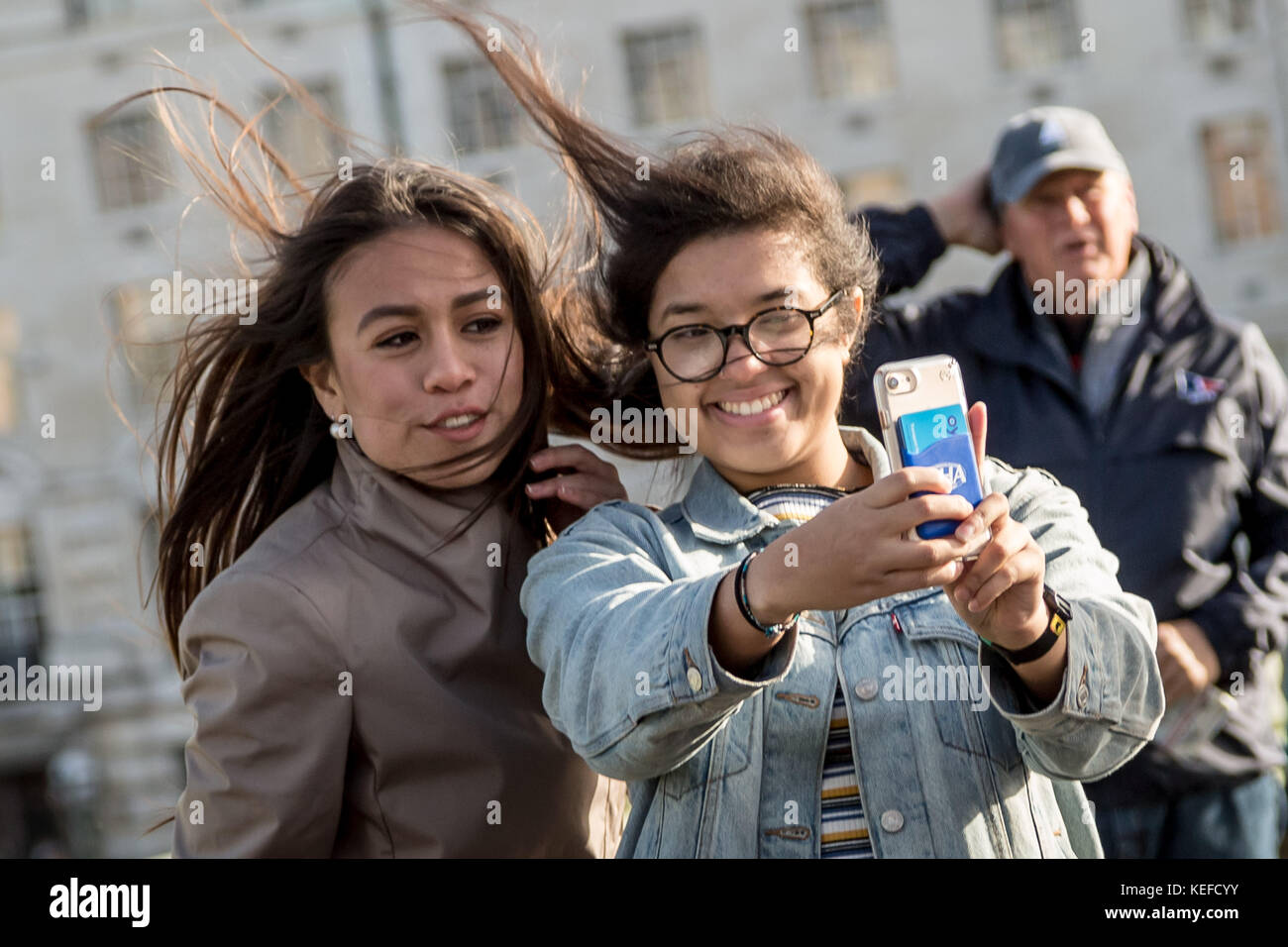 London, UK. 21st Oct, 2017. UK Weather: Storm Brian brings strong winds to city tourists on Waterloo bridge. Credit: Guy Corbishley/Alamy Live News Stock Photo