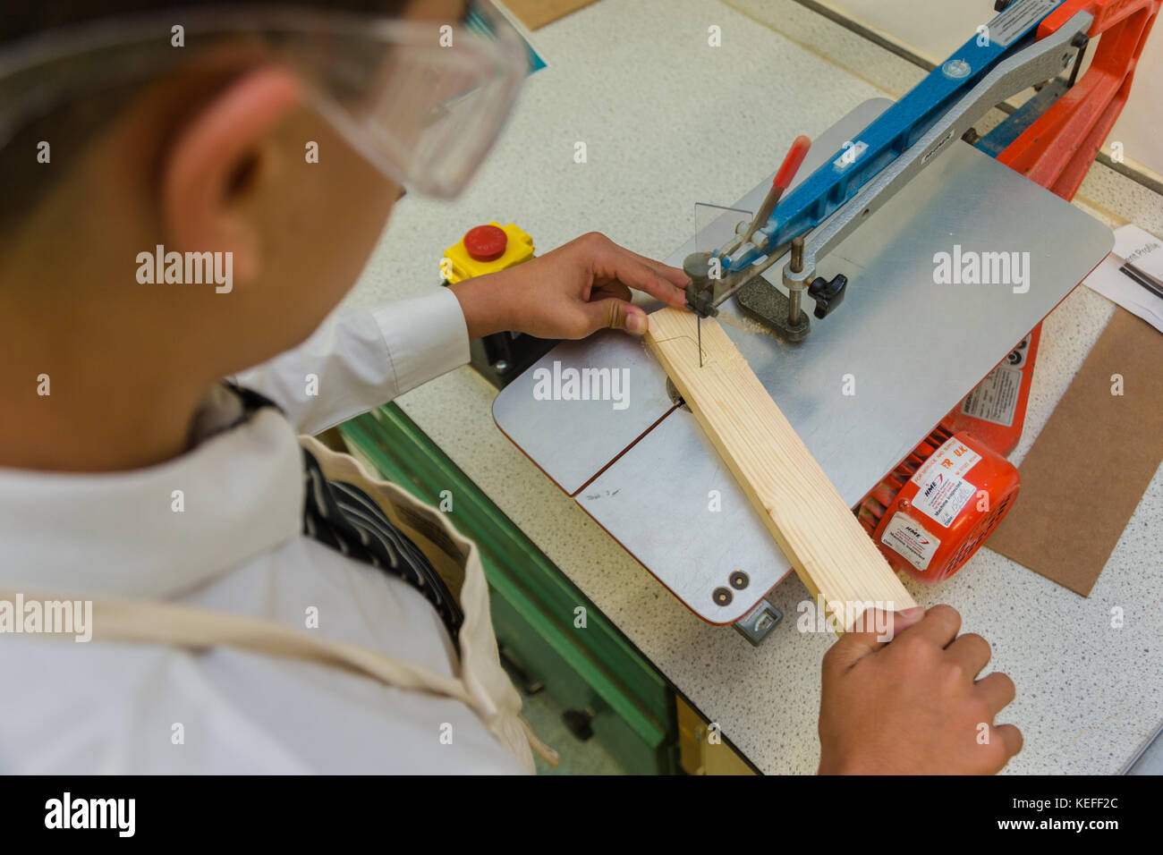 Secondary school pupil using bench tools in a technology lesson UK Stock Photo