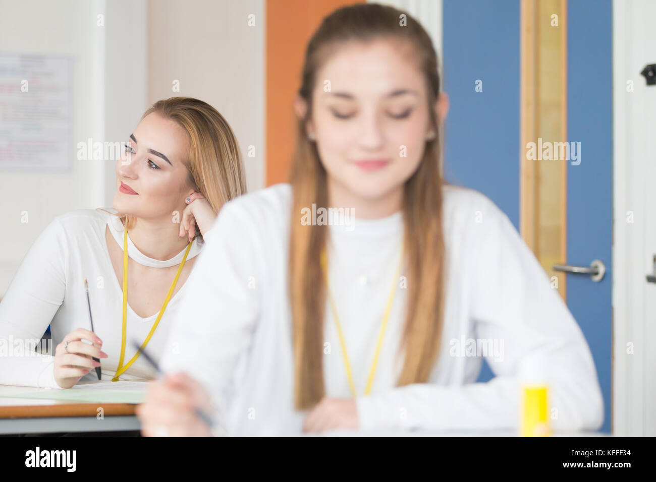 Pretty sixth form student being attentive and enjoying her school lesson UK Stock Photo