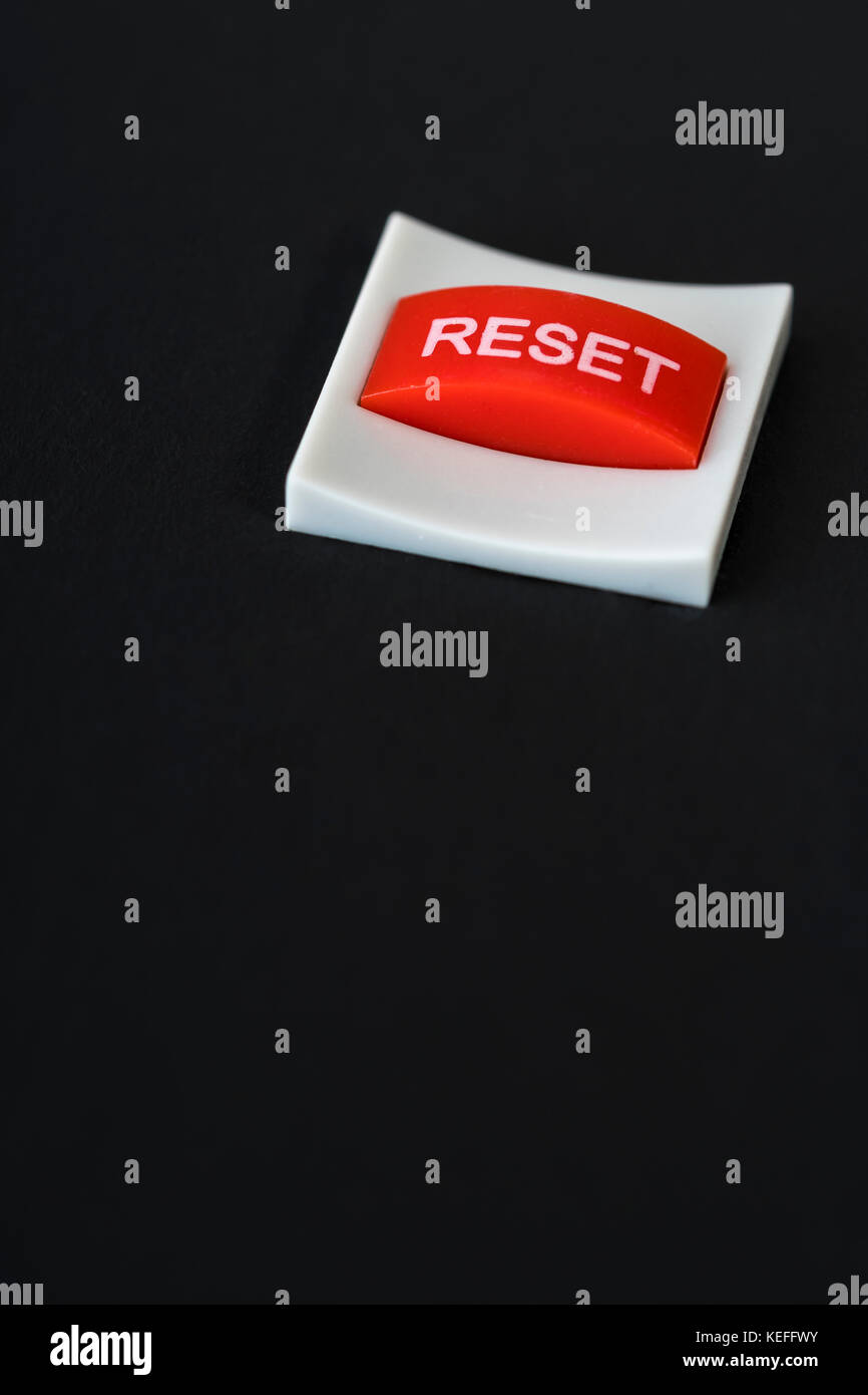 Macro-photo of small red Reset button - visual metaphor for staring over, reset, start again etc. Stock Photo
