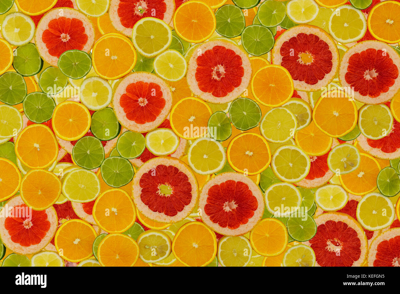 Slices of various citrus fruits on white background Stock Photo - Alamy