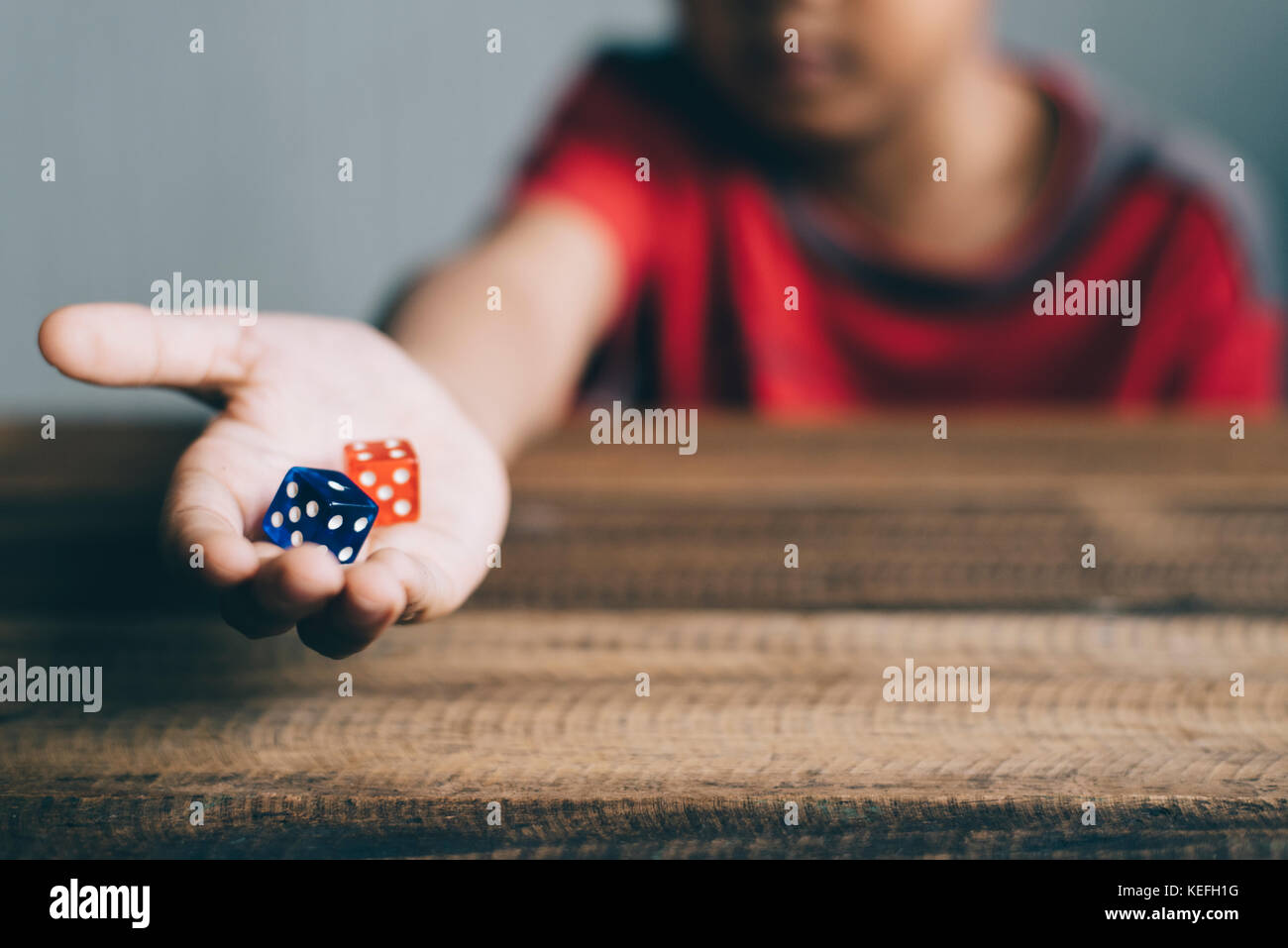 young boy showing dice Stock Photo Alamy