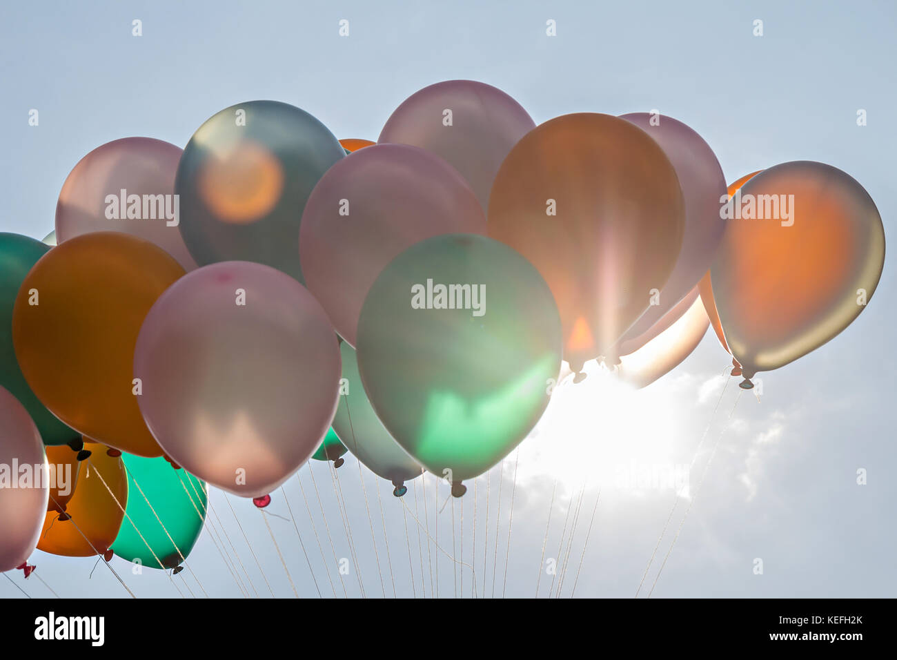 Colorful balloon against sunlight with flare on sky Stock Photo Alamy