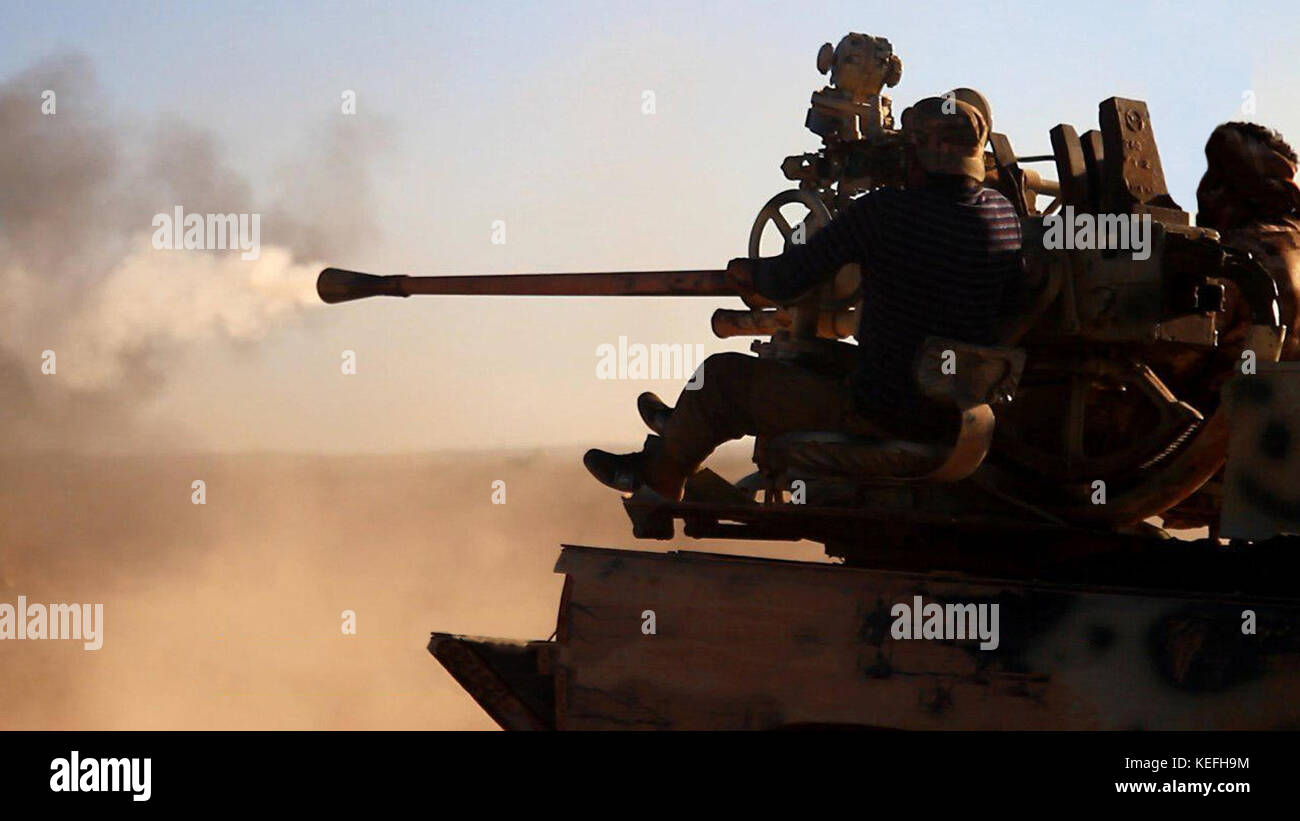 Still image taken from a propaganda video released October 18, 2017 showing Tahrir al-Sham in clashes against the Islamic State firing a heavy machine gun from the back of a pickup truck during battles east of Hama, Syria. HTS jihadists formed from former al-Nusra Front fighters have been fighting the Islamic State for control or the region. Stock Photo