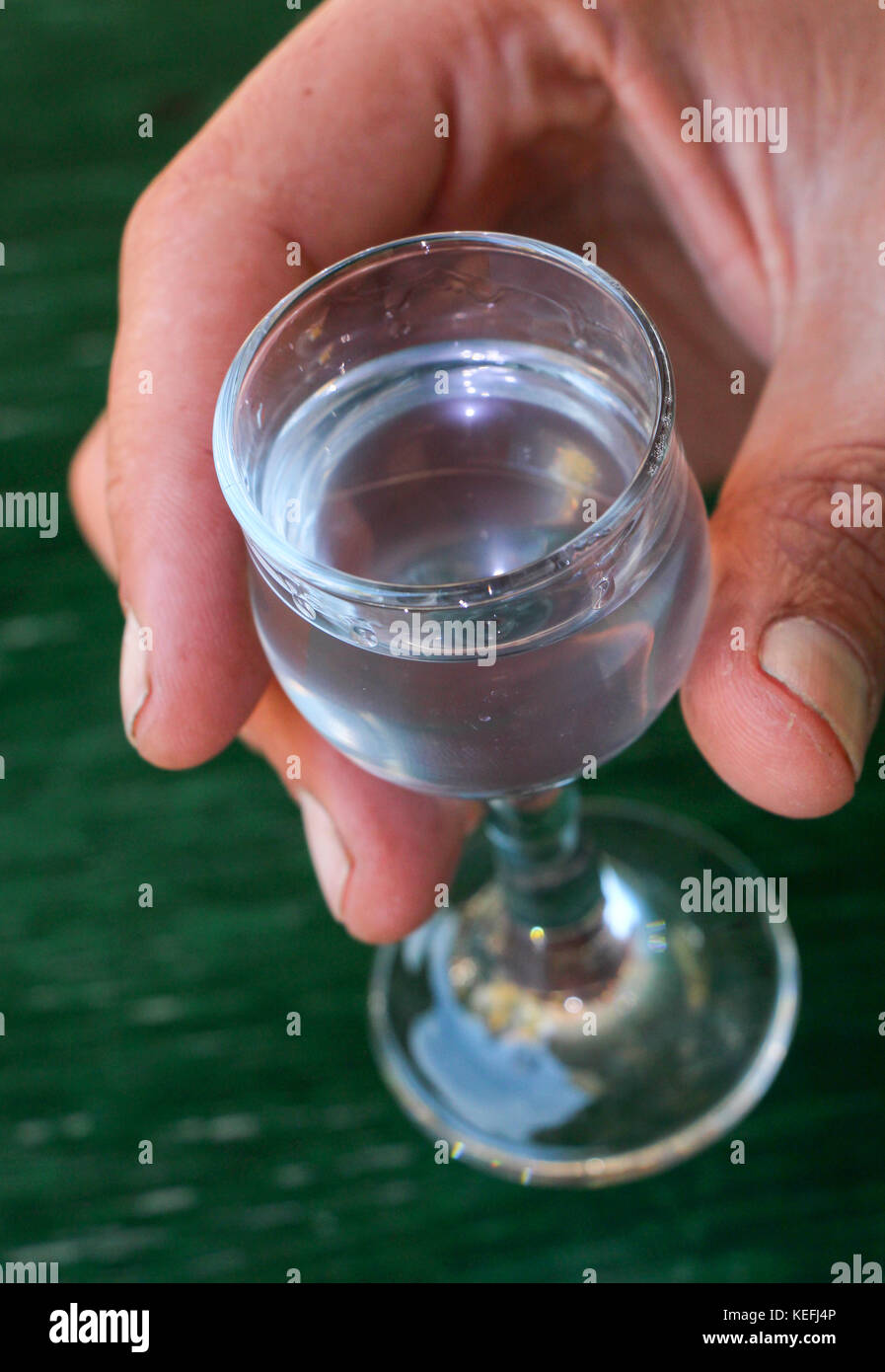 Macedonia Rakia cold served macedonian rakia glass in a worker hand,shallow dof Stock ...
