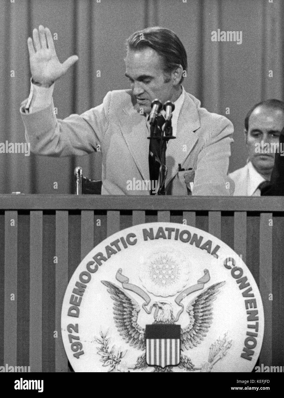 Governor George Wallace (Democrat of Alabama) a candidate for the Democratic Party nomination for President of the United States, waves from the podium as he speaks at the 1972 Democratic National Convention in Miami, Florida from the wheelchair he has had since the attempt on his life earlier this year on July 12, 1972.  In his remarks, Wallace laid down an eight-point program which included a strong anti-bussing stand which was later rejected by the convention.  Further he promised not to form a third-party if his candidacy and program were rejected by the convention delegates. Credit: Arnie Stock Photo