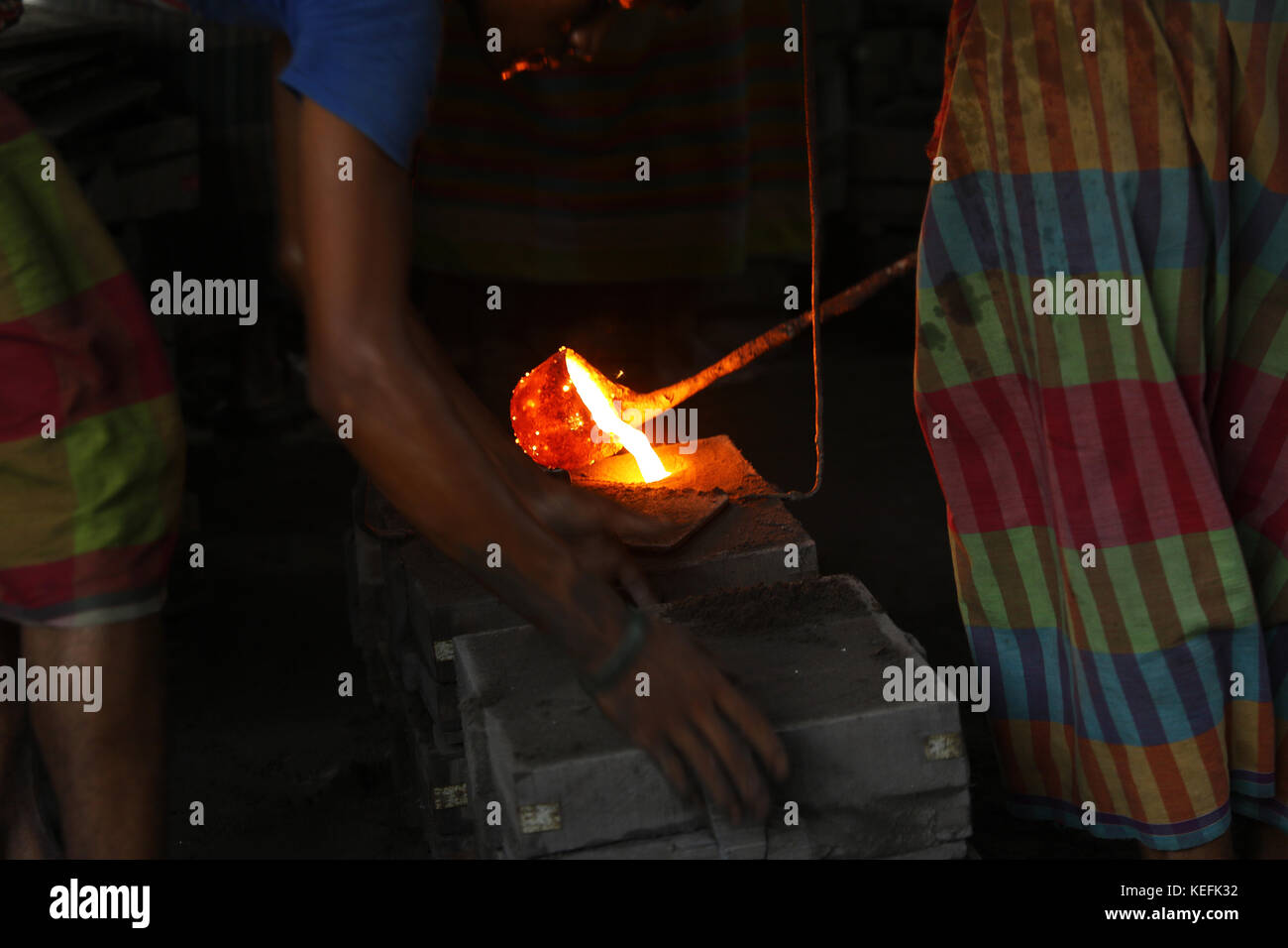 Workers in the steel re-rolling mills work without proper safety gear or tools. In these mills iron is forged in 1200 + to 1300+ Celsius. In such a he Stock Photo