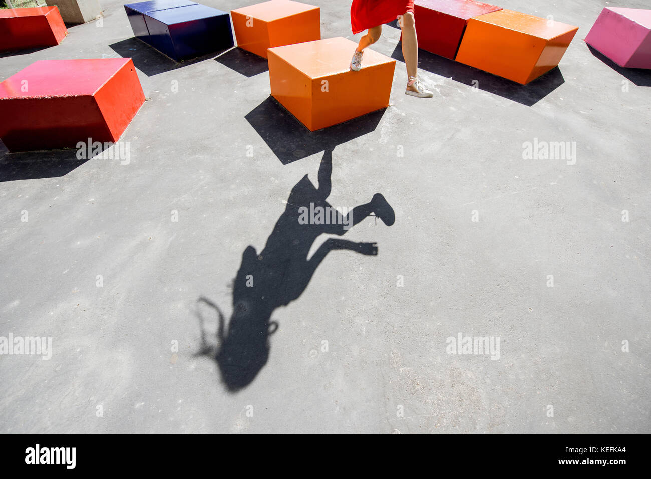 Shadow of a woman on the ground with boxes Stock Photo - Alamy
