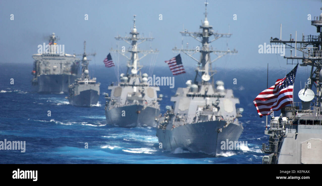 Pacific Ocean - June 18, 2006 -- USS Cowpens (CG 63) (foreground) is followed by USS Lassen (DDG 82), USS John S. McCain (DDG 56), USS Vandegrift (FFG 48) and USNS Tippecanoe (T-AO 199) during a photo exercise to kick off Exercise Valiant Shield 2006.  The Kitty Hawk Carrier Strike Group is currently participating in Valiant Shield 2006, the largest joint exercise in recent exercise Valiant Shield.  Held in the Guam operating area June 19-23, the exercise involves 28 Naval vessels including three carrier strike groups.  Nearly 300 aircraft and approximately 22,000 service members from the Navy Stock Photo