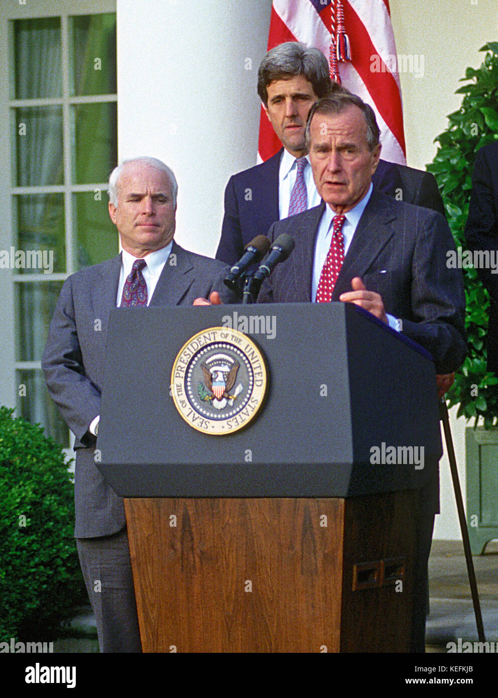 Washington, DC - (FILE) -- United States President George H.W. Bush announces the Government of Vietnam has agreed to make available all information including photographs, artifacts, and military documents on United States prisoners of war (POWs) and those missing in action (MIAs) in the Rose Garden of the White House on Friday, October 23, 1992.  Pictured from left to right: United States Senator John McCain (Republican of Arizona); United States Senator John F. Kerry (Democrat of Massachusetts); and President Bush..Credit: Ron Sachs / CNP /MediaPunch Stock Photo