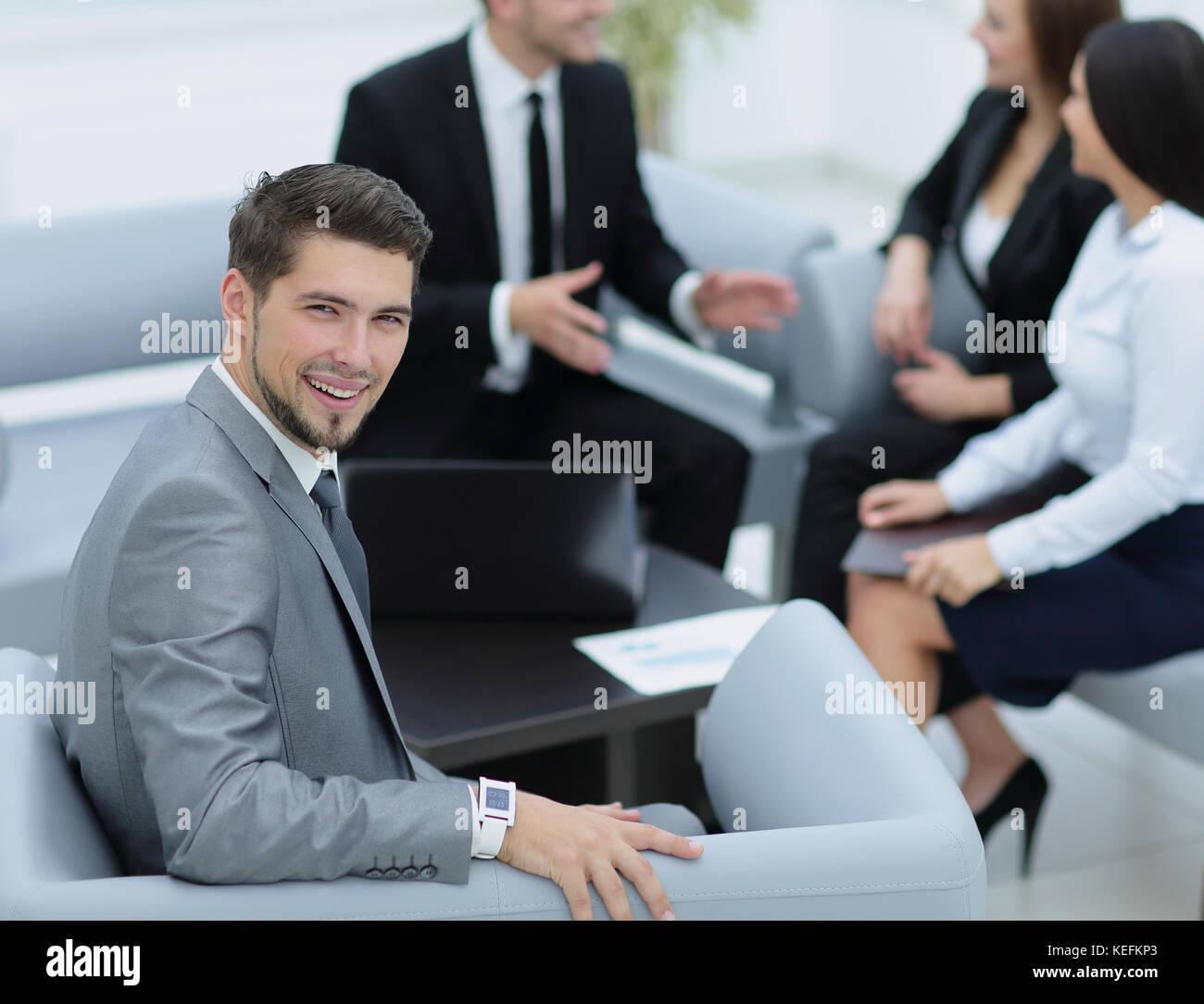 Portrait of business man looking at camera and smiling with his staff ...