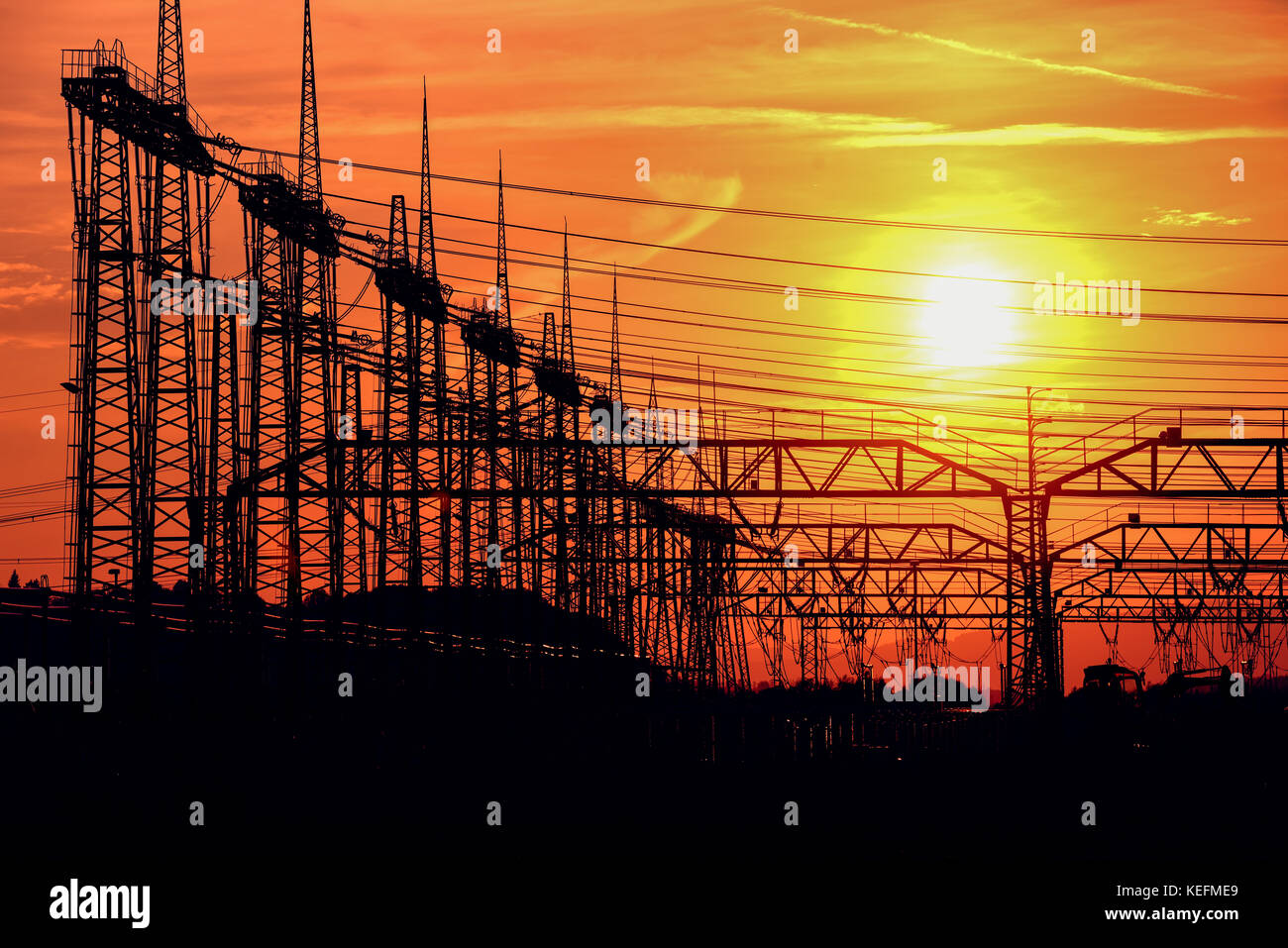 A PYLON AND HIGH-VOLTAGE POWER LINES, SUNSET, RED SKY Stock Photo - Alamy