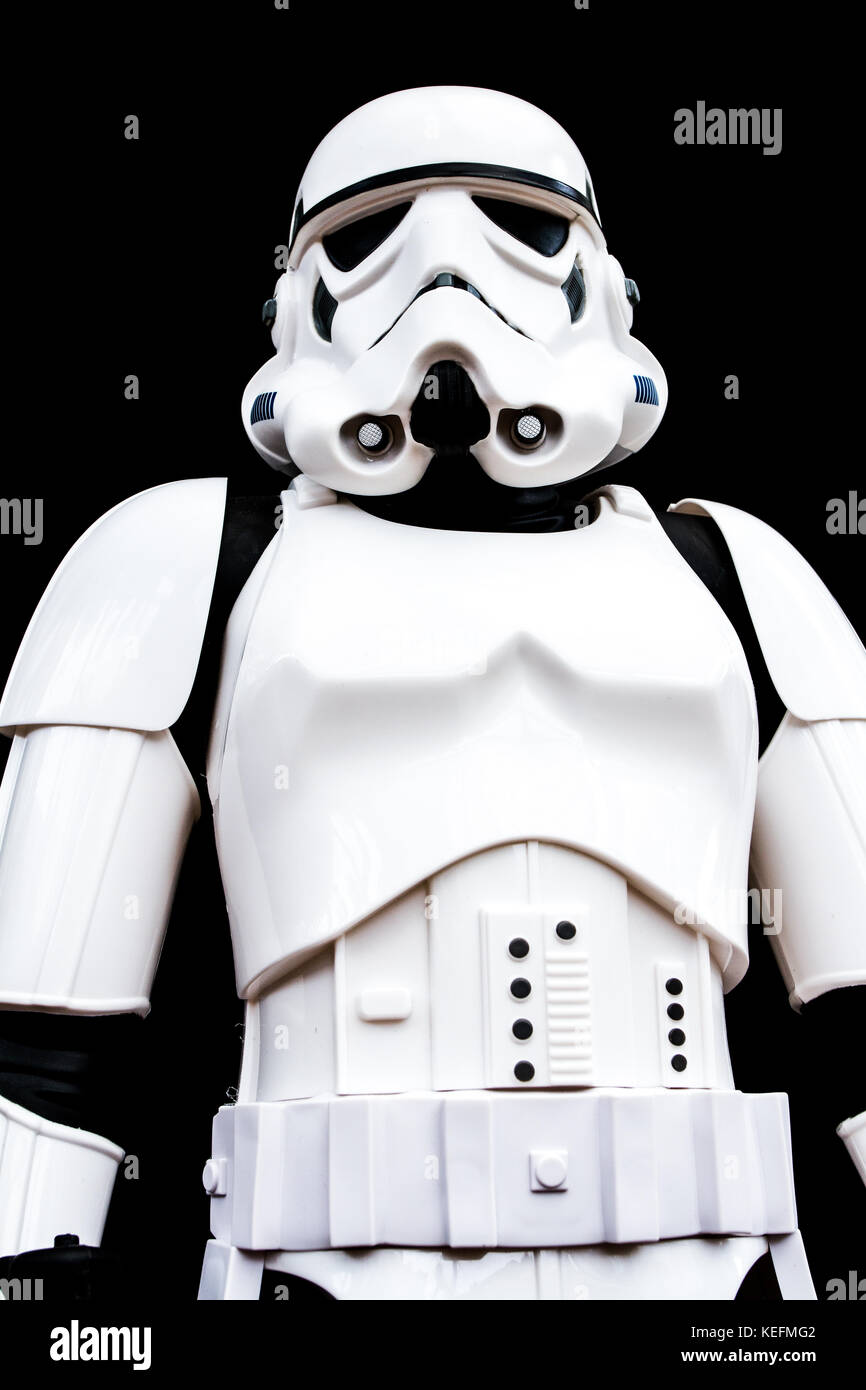 UK - July 7, 2016. A low angle view of the portrait of a Stormtrooper from the Star Wars movie franchise looking threatening on a black background. Stock Photo