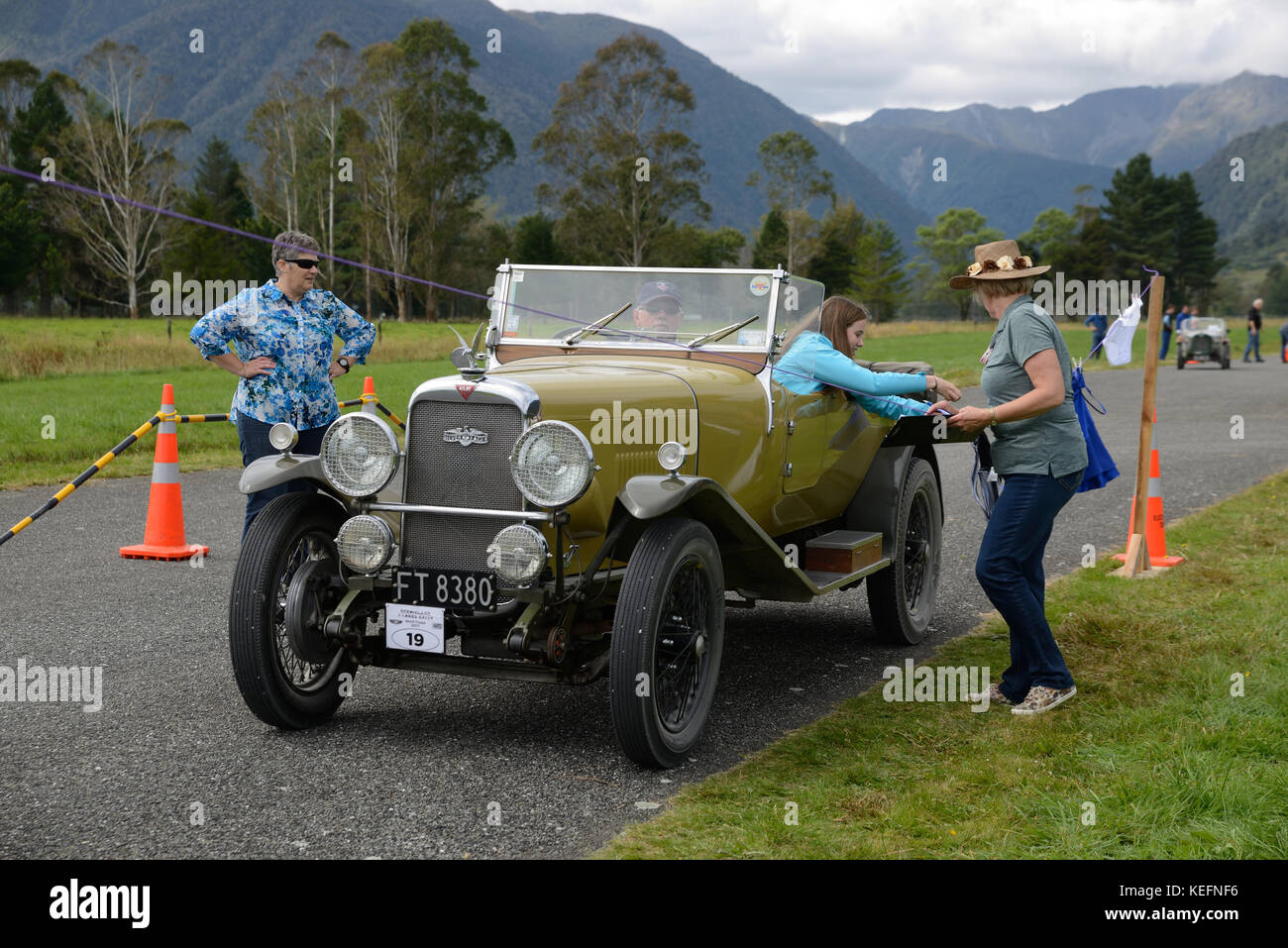 HAUPIRI, NEW ZEALAND, MARCH 18, 2017: Contestants in a vintage car rally hang out washing in a timed competition. The vehicle is a 1930 Alvis  Silver  Stock Photo