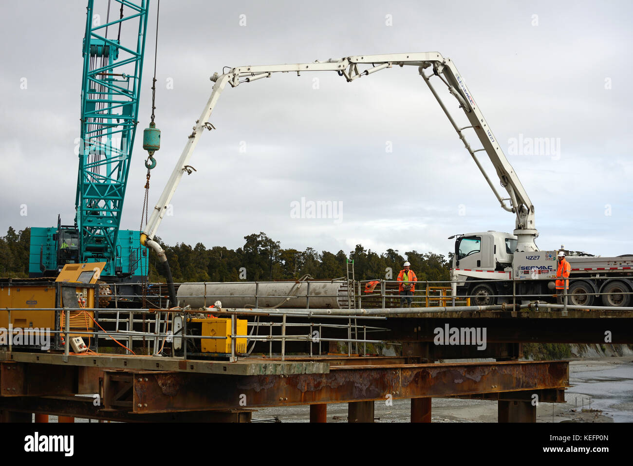 GREYMOUTH, NEW ZEALAND, SEPTEMBER 20, 2017: Builders construct a new bridge over the Taramakau River in Westland, New Zealand Stock Photo