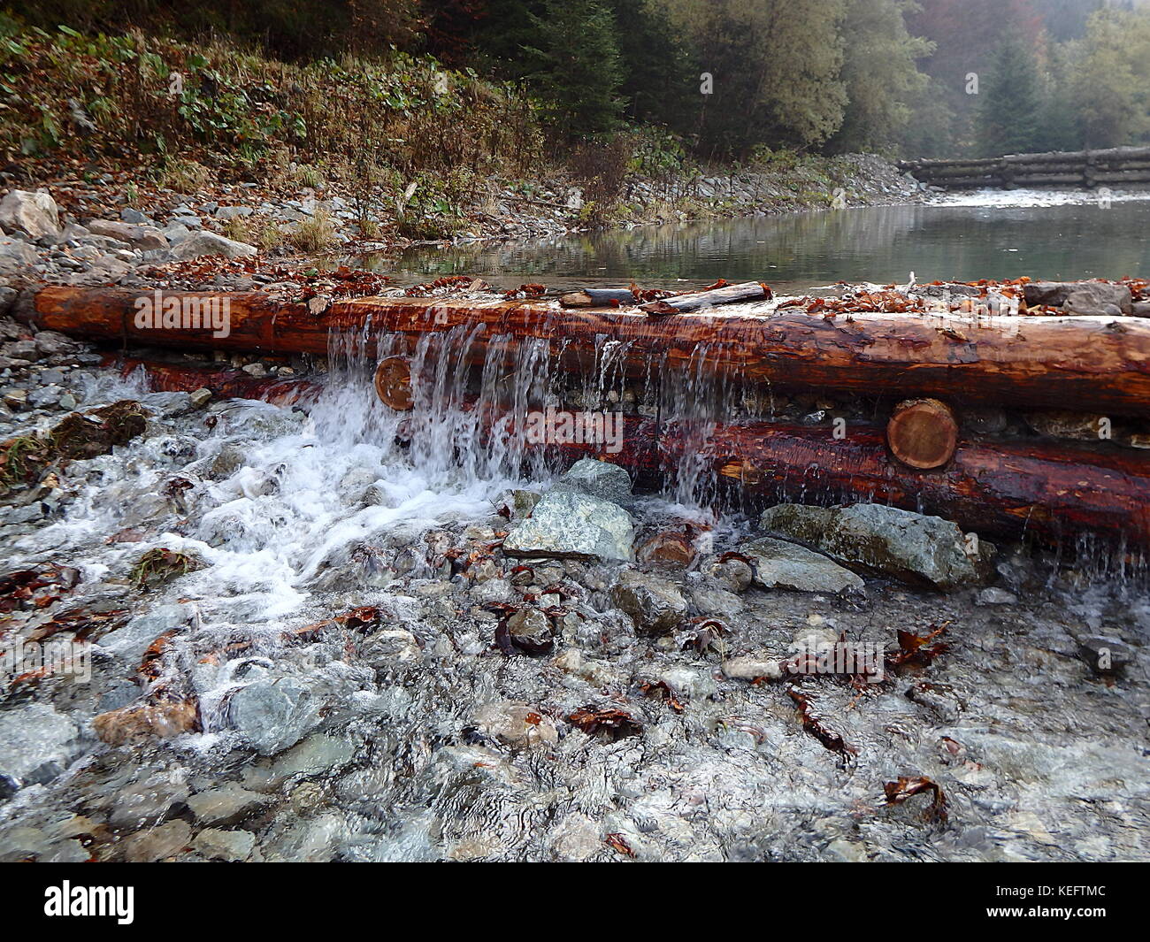 Wooden dam on a mountain river, Traditional structure for floating