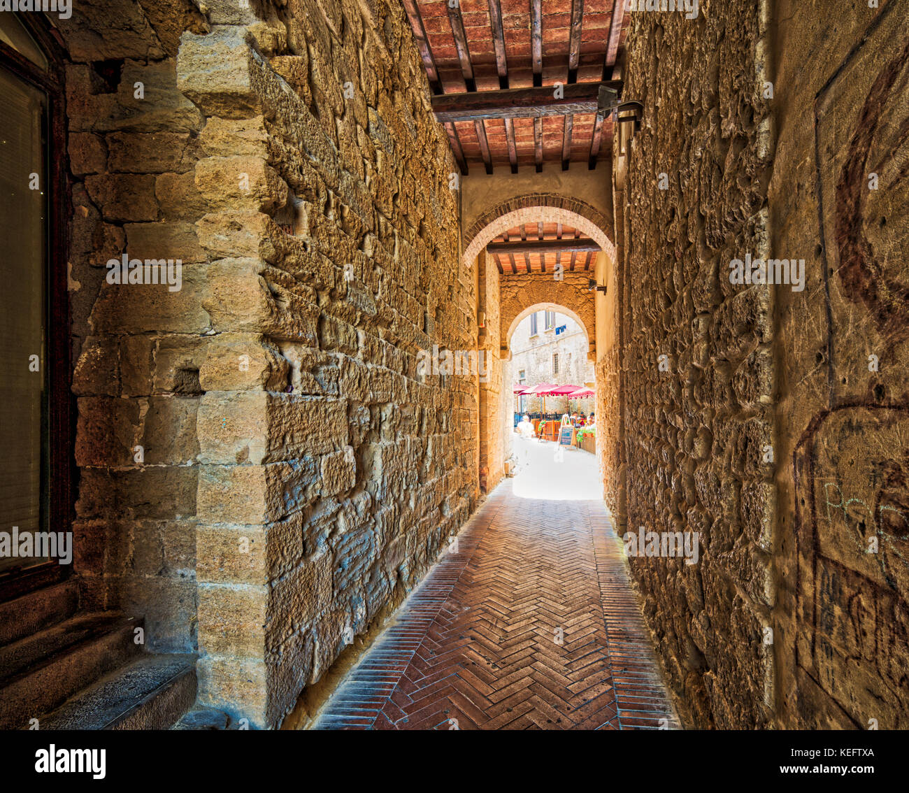 stone arch in street of Volterra, Italy Stock Photo - Alamy