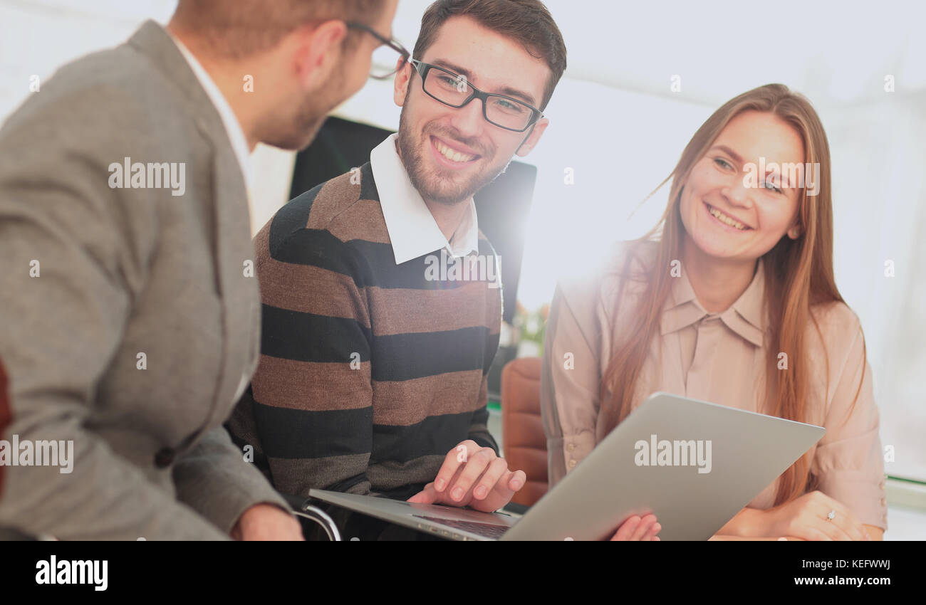 Group of young business people gathered together discussing creative ...