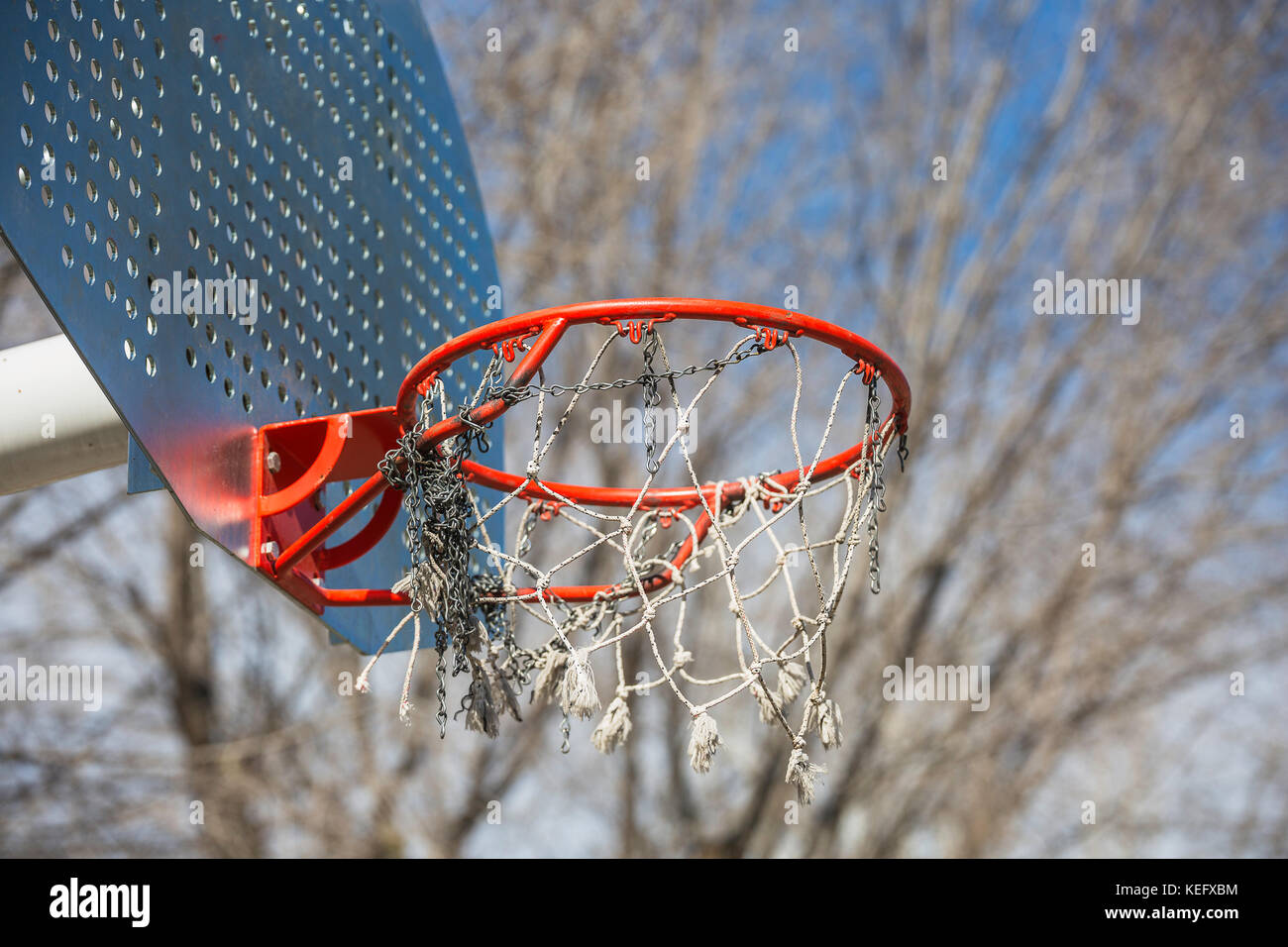 orange Basketball hoop in the park with tangled chain Stock Photo Alamy