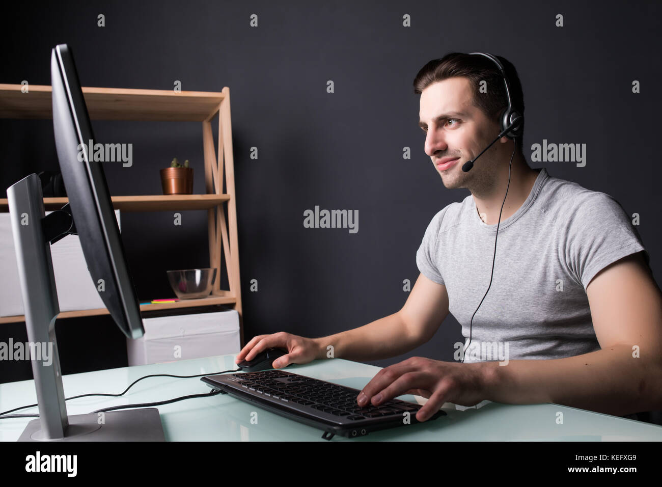 Happy guy in front of the monitor at home Stock Photo Alamy