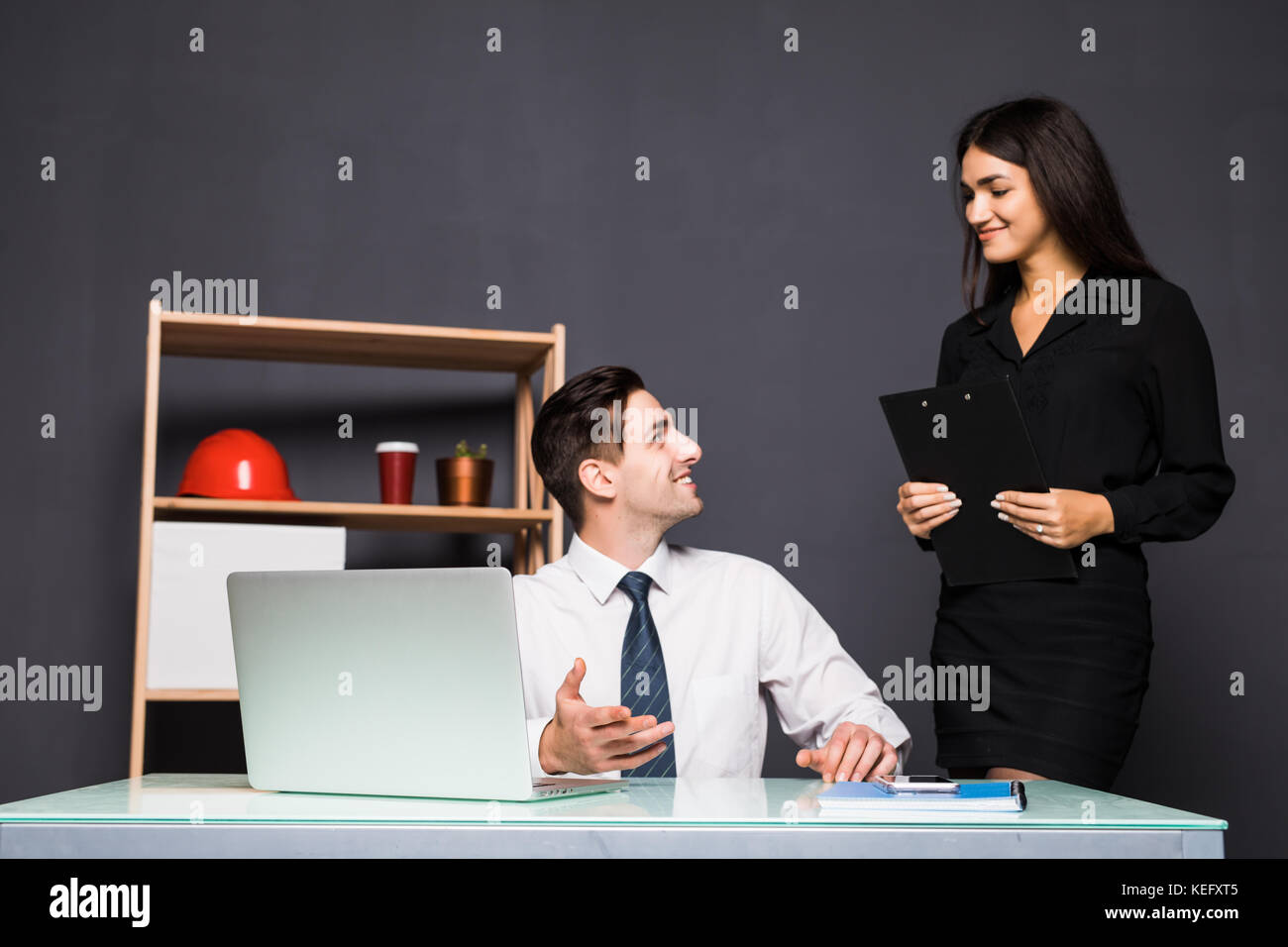 Young office workers in front of desktop computer Stock Photo