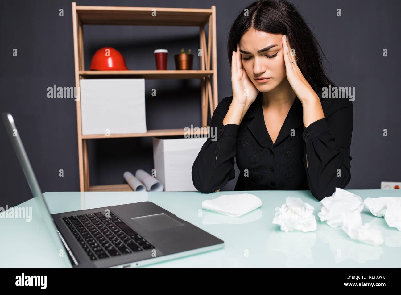 Young attractive woman at modern office desk, working on laptop ...