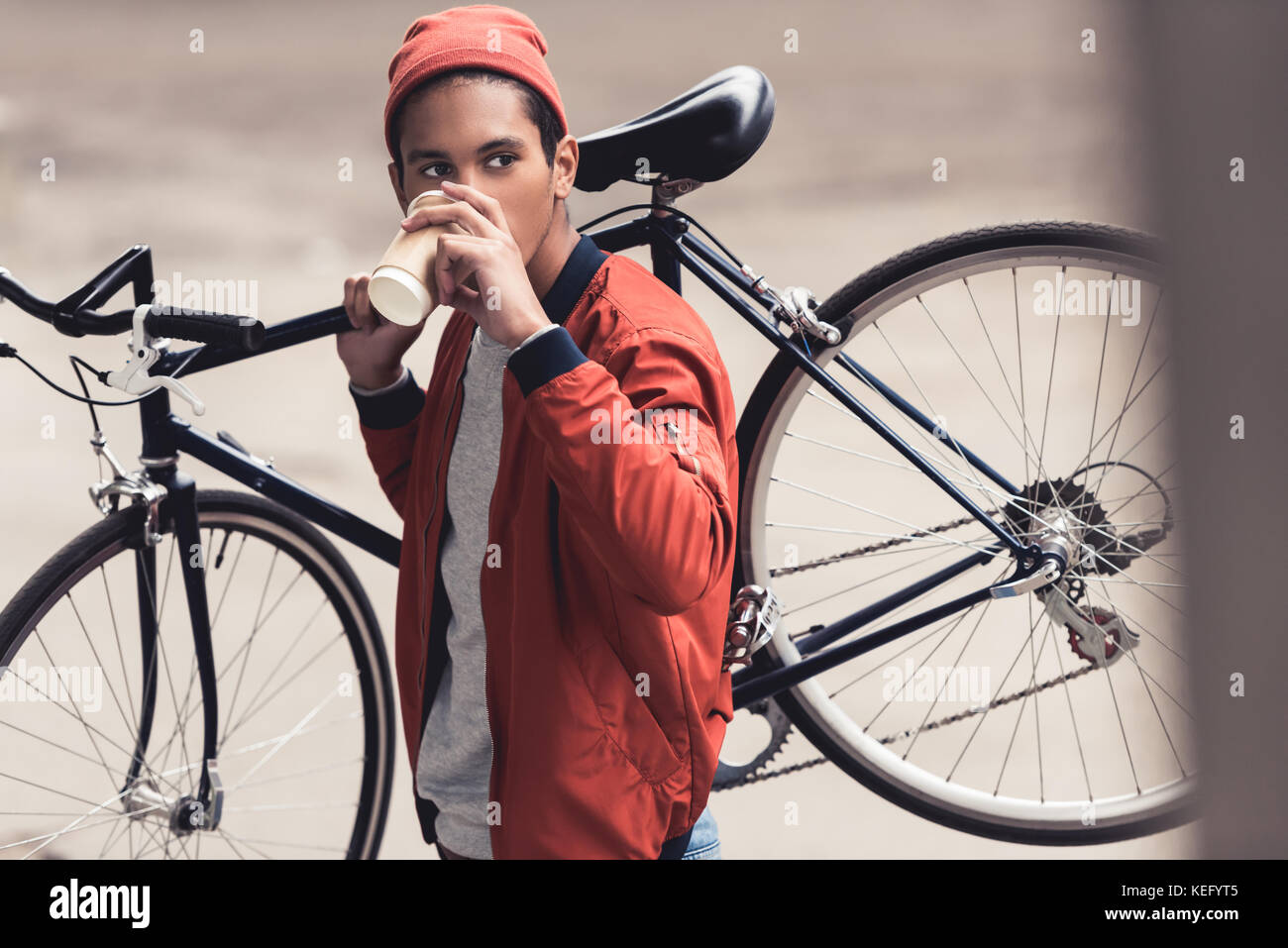 man with vintage bicycle drinking coffee to go and looking away Stock ...