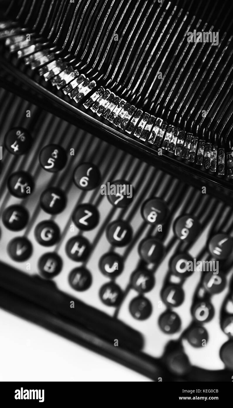 Vintage manual typewriter machine vertical fragment, letters and keys, black and white photo with soft selective focus Stock Photo