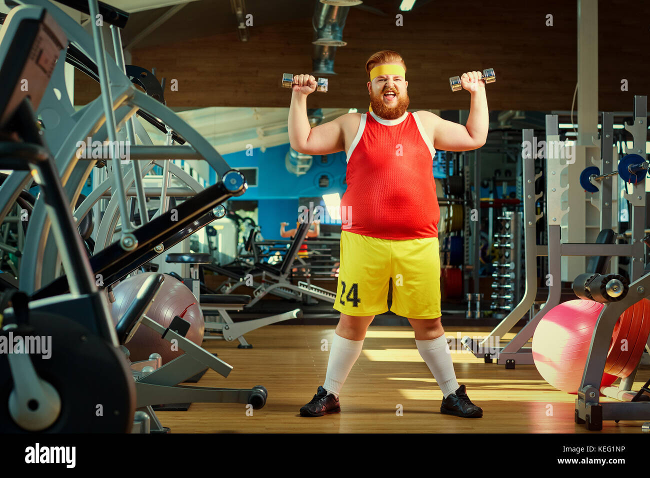 Fat funny man in the gym. Stock Photo