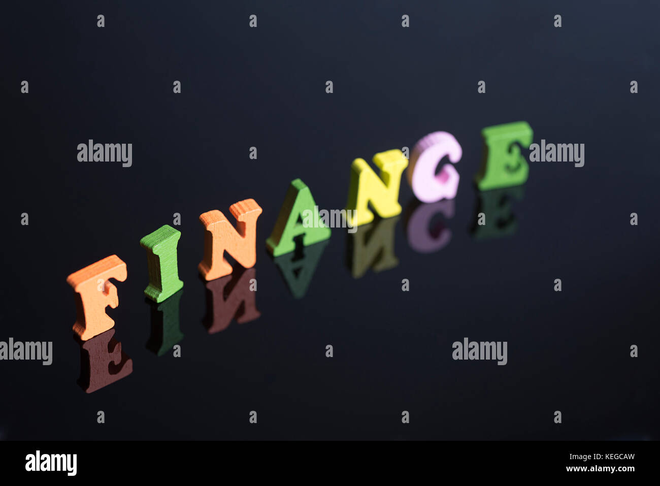 The word Finance of colored letters on black background Stock Photo - Alamy