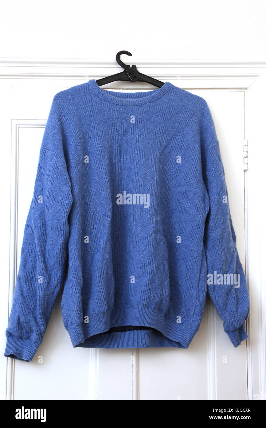 Proquip Blue Wool Jumper hanging on door Stock Photo Alamy