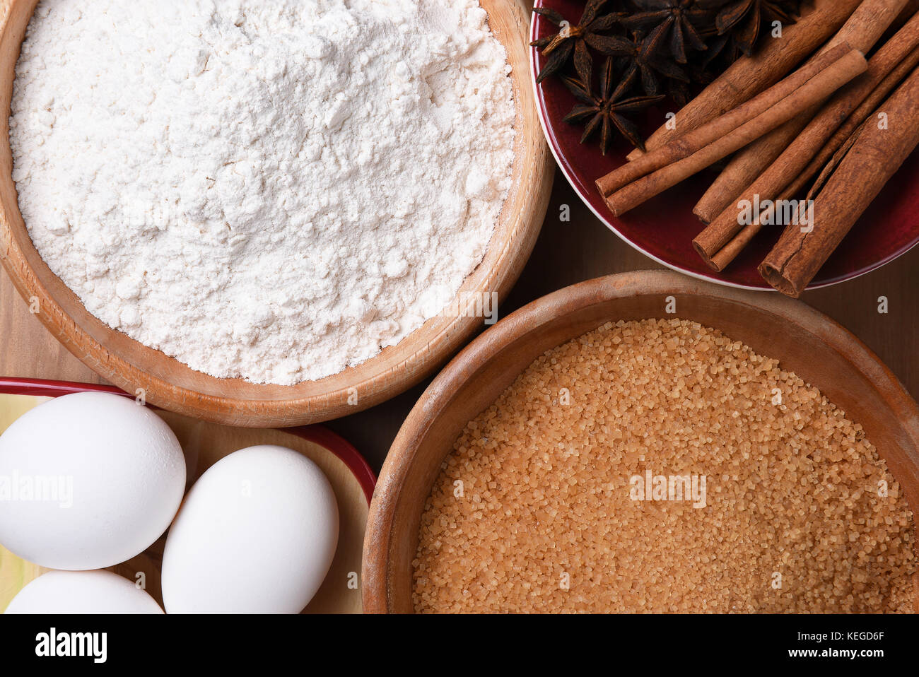 Holiday Baking: Still Life closeup of bowls full of sugar, flour, eggs, cinnamon and star anise in preparation for making holiday treats. Stock Photo