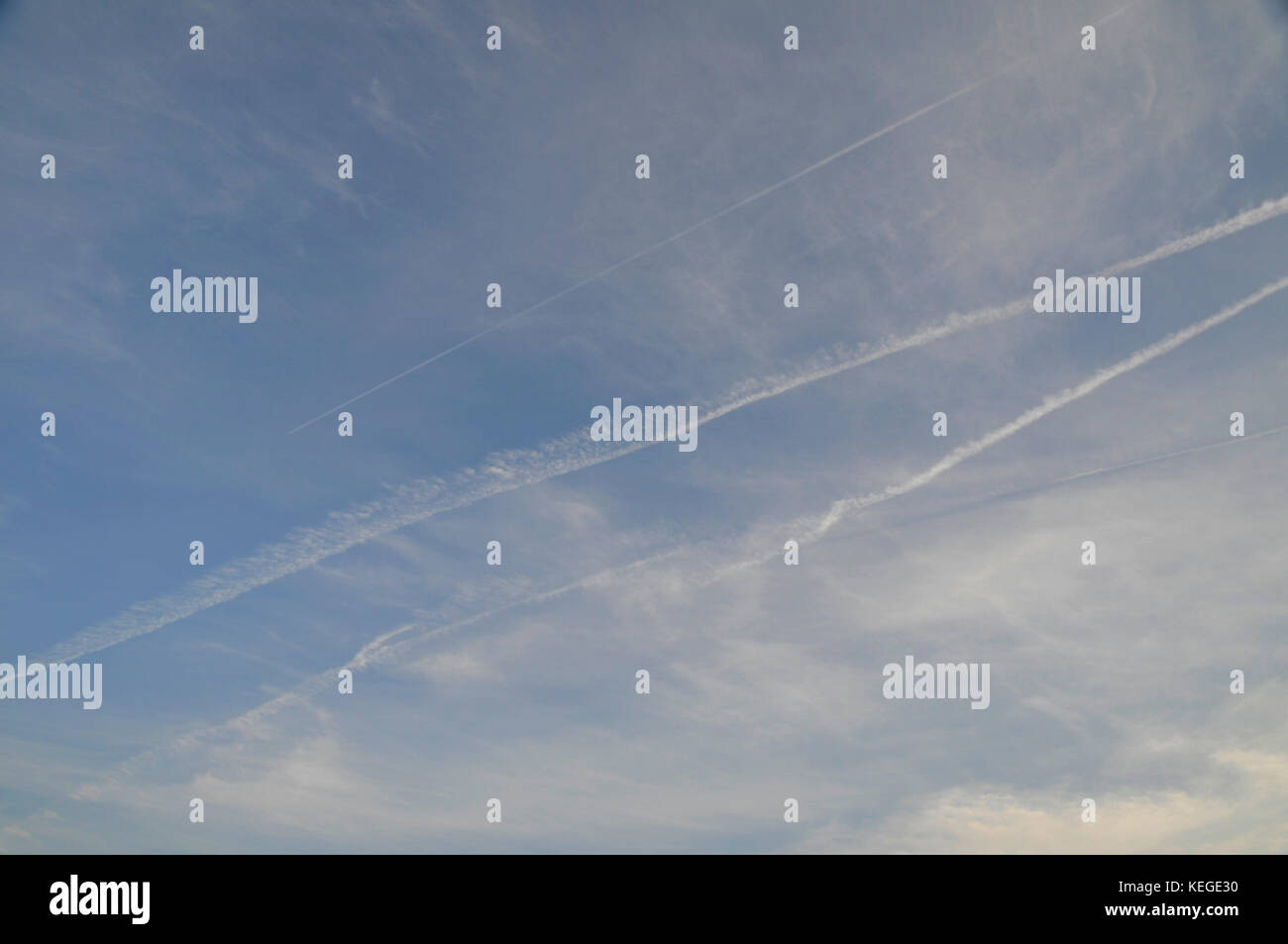 Airplane vapor trails crossing in the sky Stock Photo