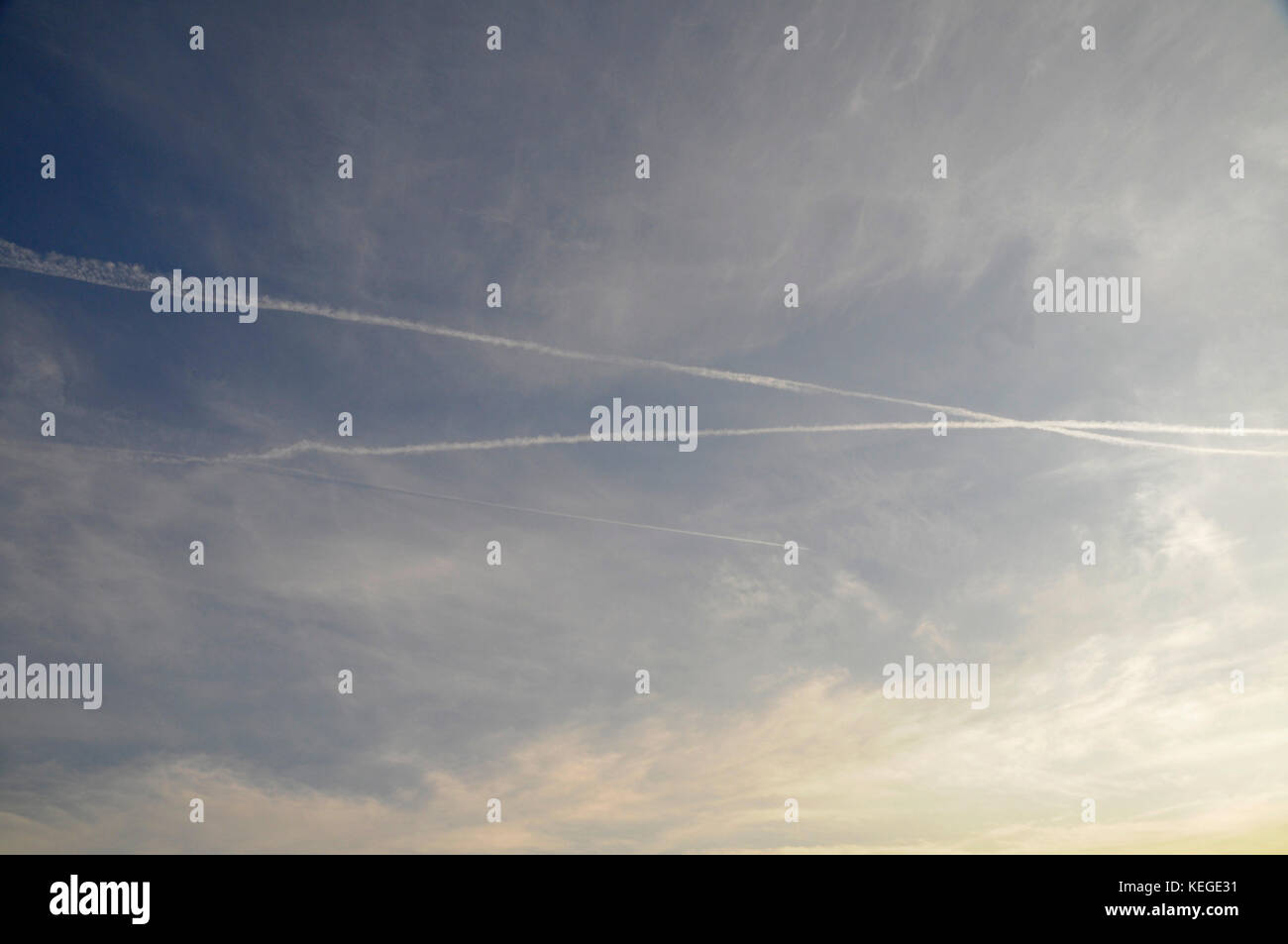 Airplane vapor trails crossing in the sky horizontal photo Stock Photo