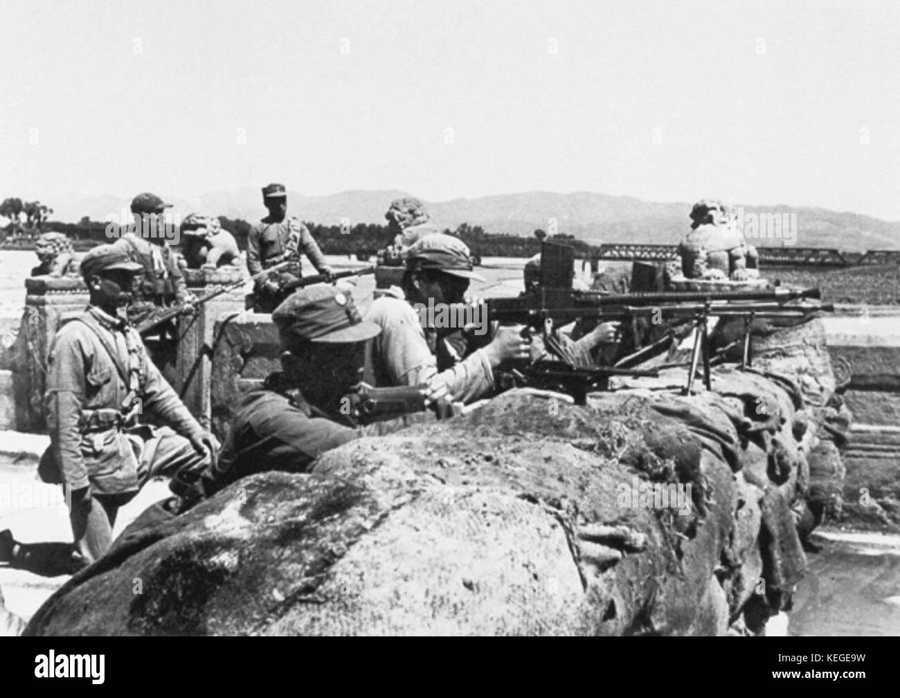 Above: Chinese soldiers defending the Marco Polo Bridge in July 1937.  Right: Japanese magazine cover showing the Japanese military marching  through the gate at Chaoyangmen on August 8, after the capture of